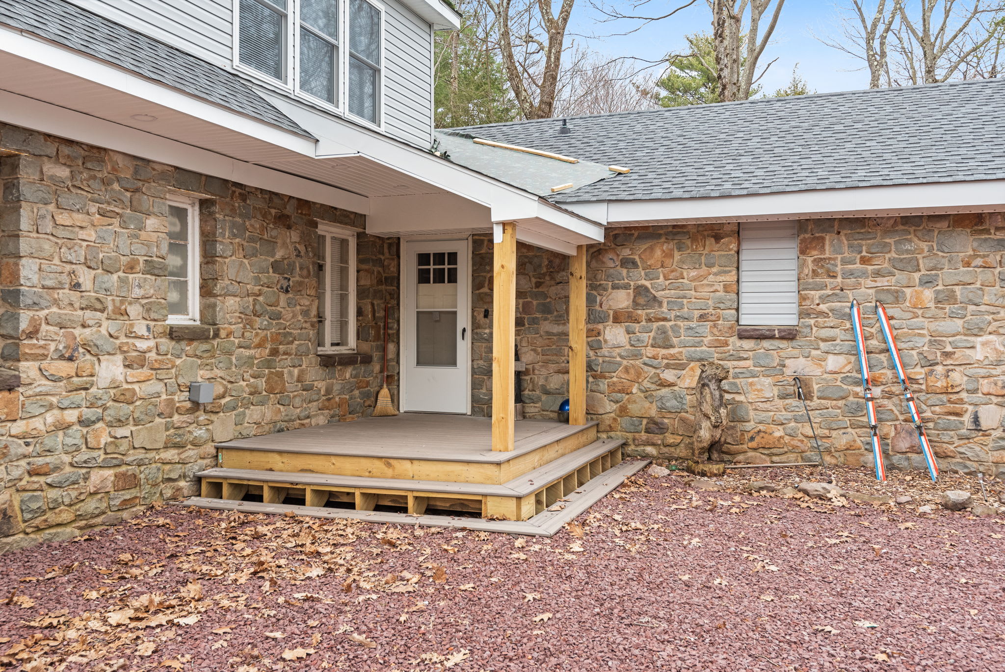 Welcoming Covered Entryway
A cozy covered porch with stone detailing and wooden accents offers a warm welcome, inviting guests into this charming and thoughtfully designed mountain retreat.