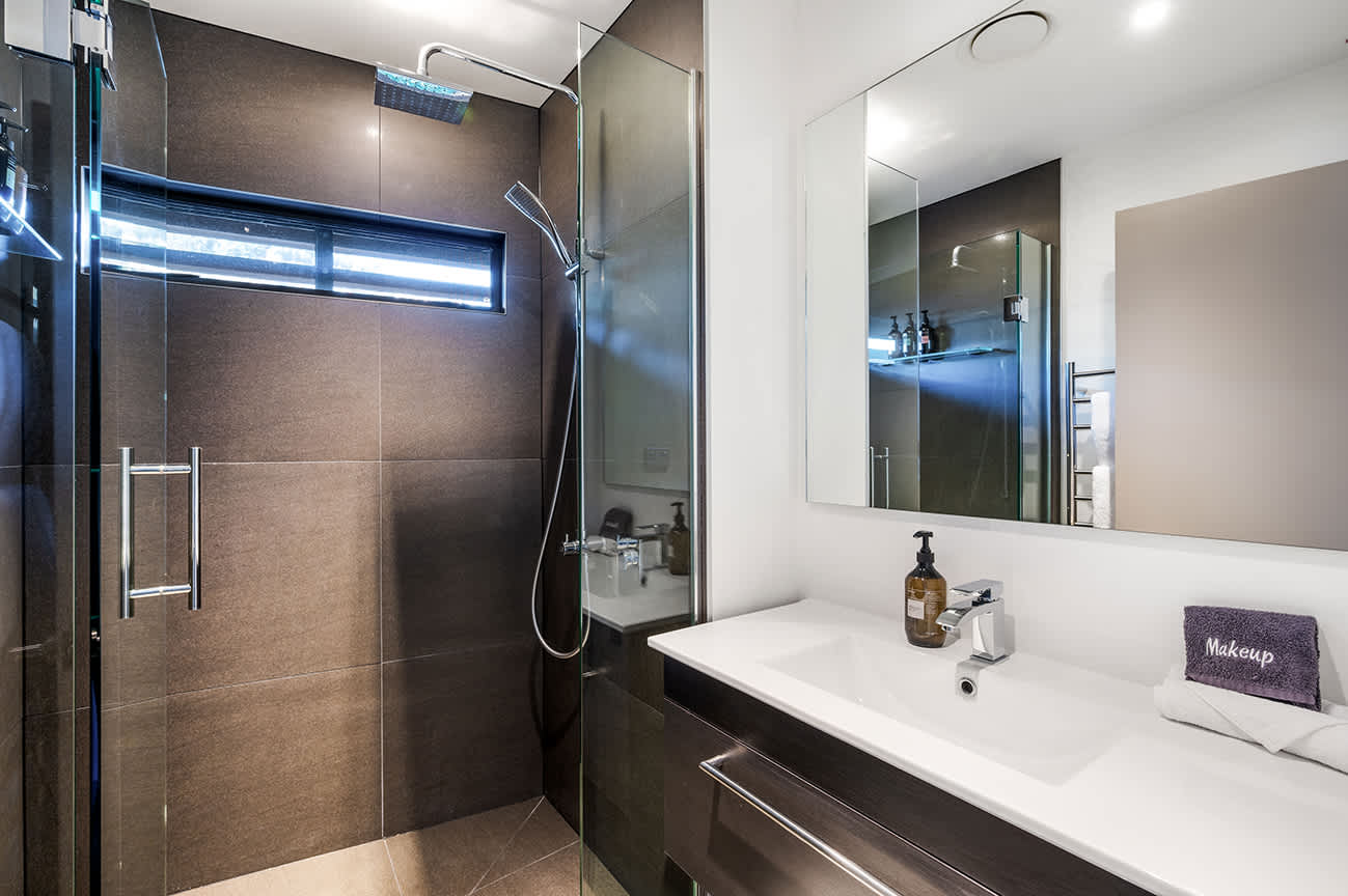 Luxurious Master Ensuite with Premium Finishes
Indulge in the comfort of this master bedroom ensuite, featuring modern fixtures, a spacious walk-in shower, and premium bath amenities. The perfect blend of luxury and relaxation.