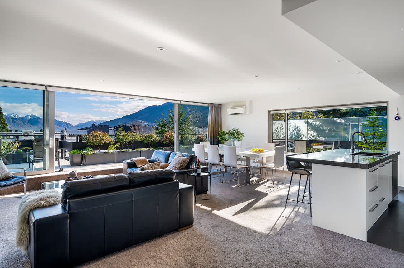 Sun-Drenched Living Space with Lake Wakatipu Backdrop
Relax in front of the fireplace in this beautifully designed living room, boasting luxury finishes and spectacular views, ideal for après-ski or unwinding after wine tours.