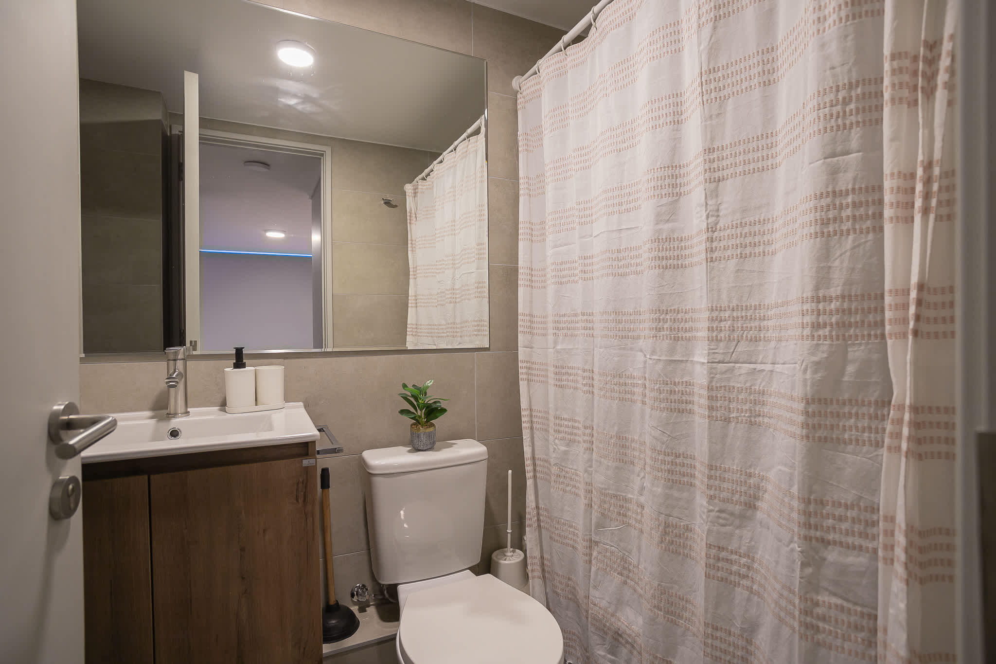 Modern bathroom with sleek fixtures and a cozy ambiance, perfect for unwinding after a day of exploring.
