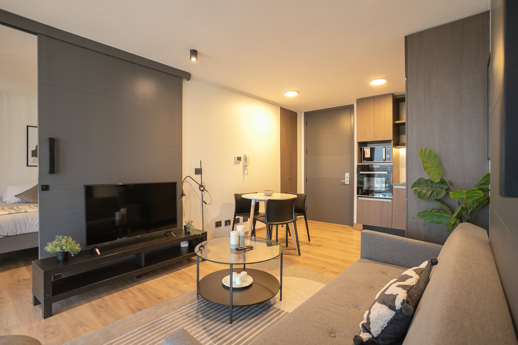 Cozy and modern living space with sleek kitchen and dining area, perfect for relaxing after exploring the vibrant city of Chile.