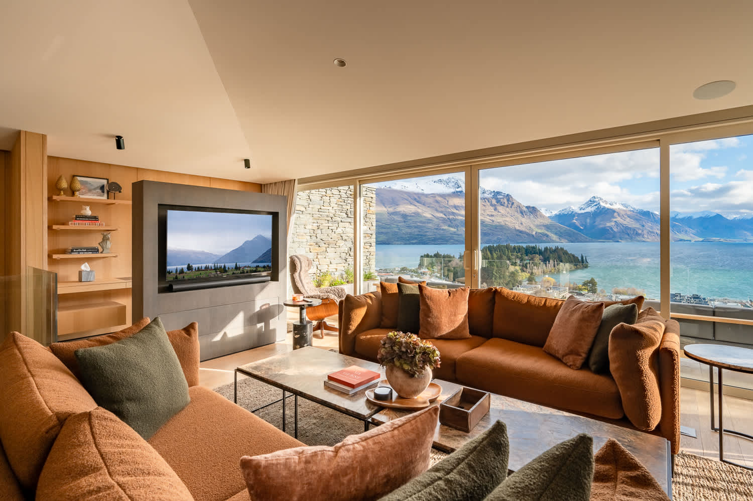 Luxury Comfort and Modern Design in Queenstown

This sophisticated living area blends modern design with cozy luxury, featuring plush seating and a fireplace, perfect for unwinding after exploring Queenstown's ski fields or wine tours.