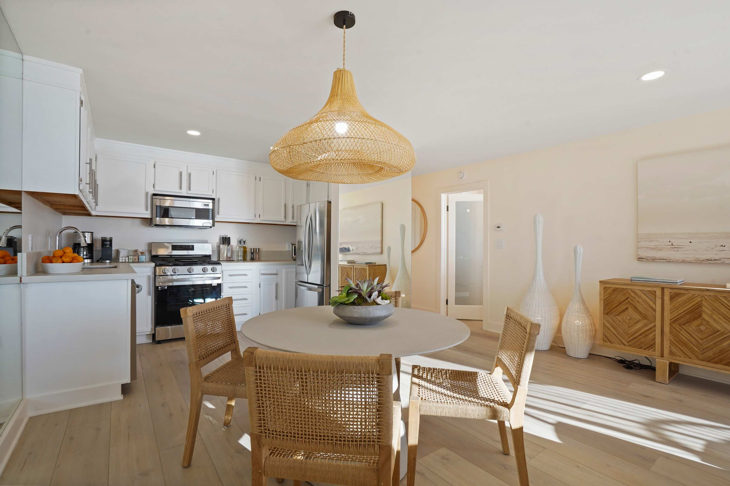 Gather around the dining table, where chic design meets the warmth of natural light.