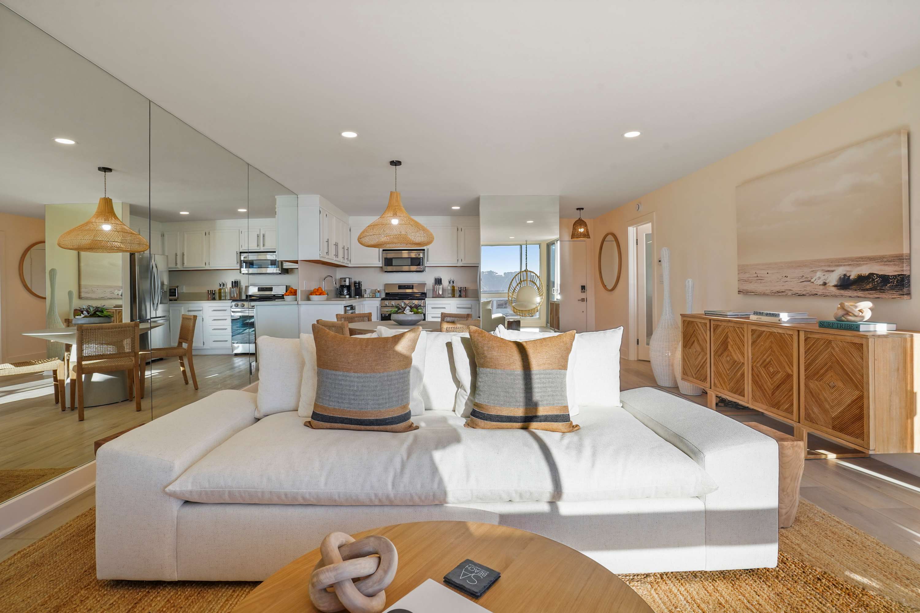Open-plan living and kitchen area with modern furnishings, perfect for a relaxed beachside experience.