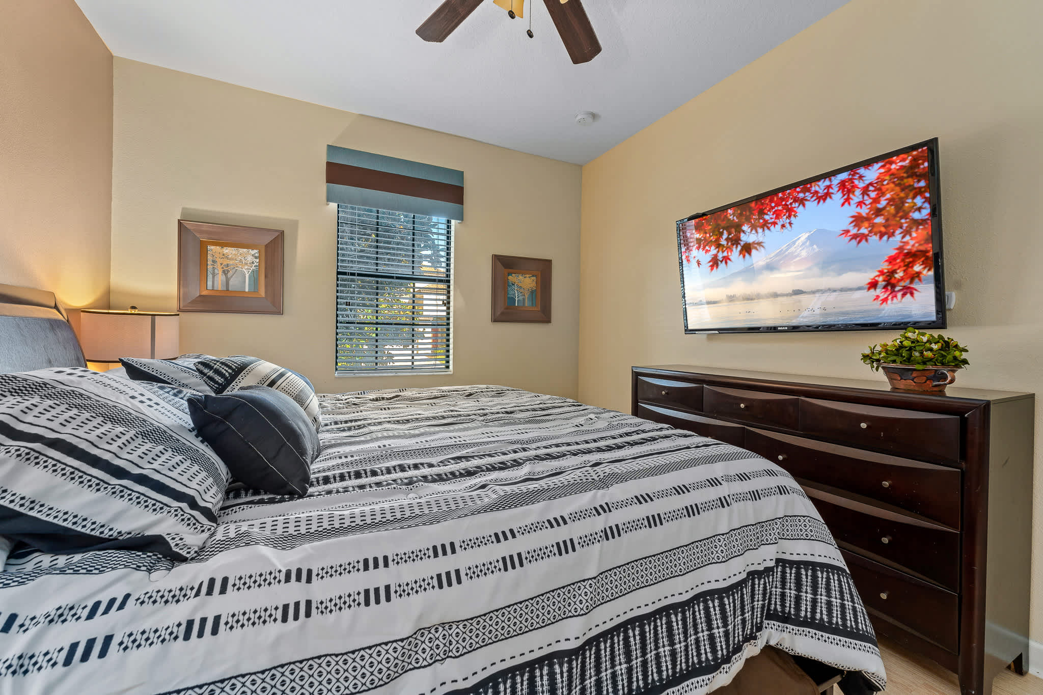 Bedroom w/ bed and wall-mounted TV for easy wind-down time.