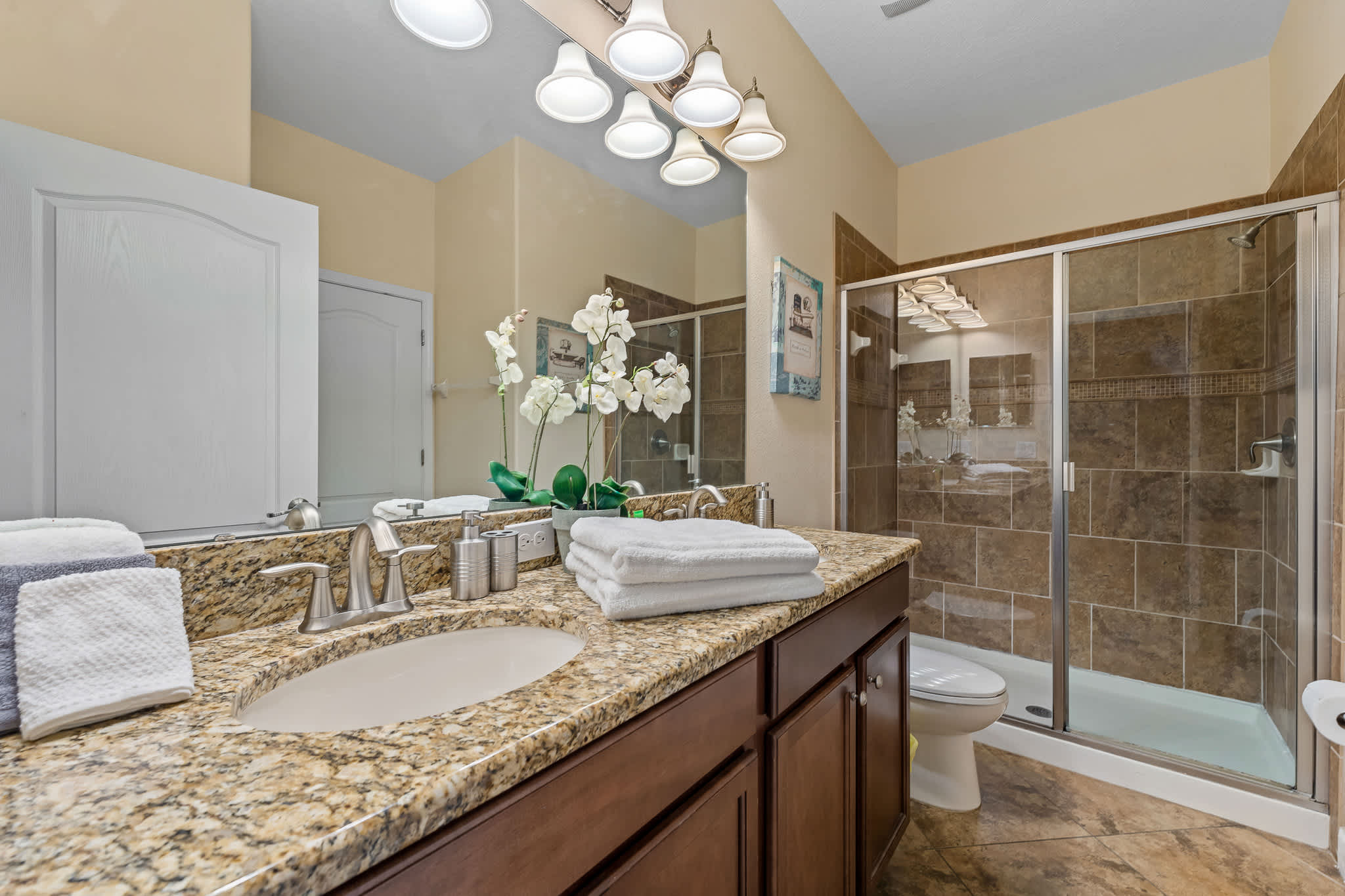 Bathroom vanity w/ sink and bright lighting for easy mornings.