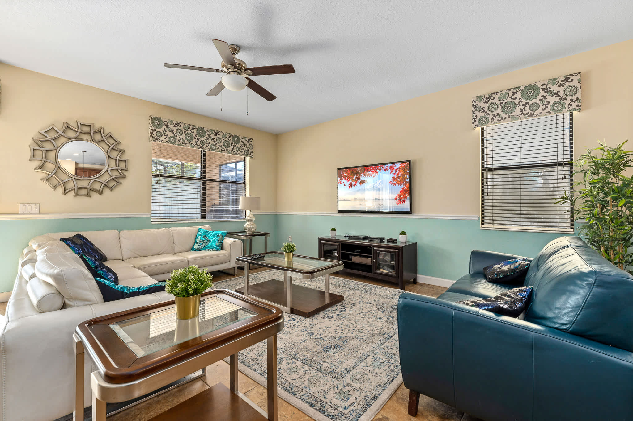 Living area w/ seating and ceiling fan, comfortable for lounging anytime.