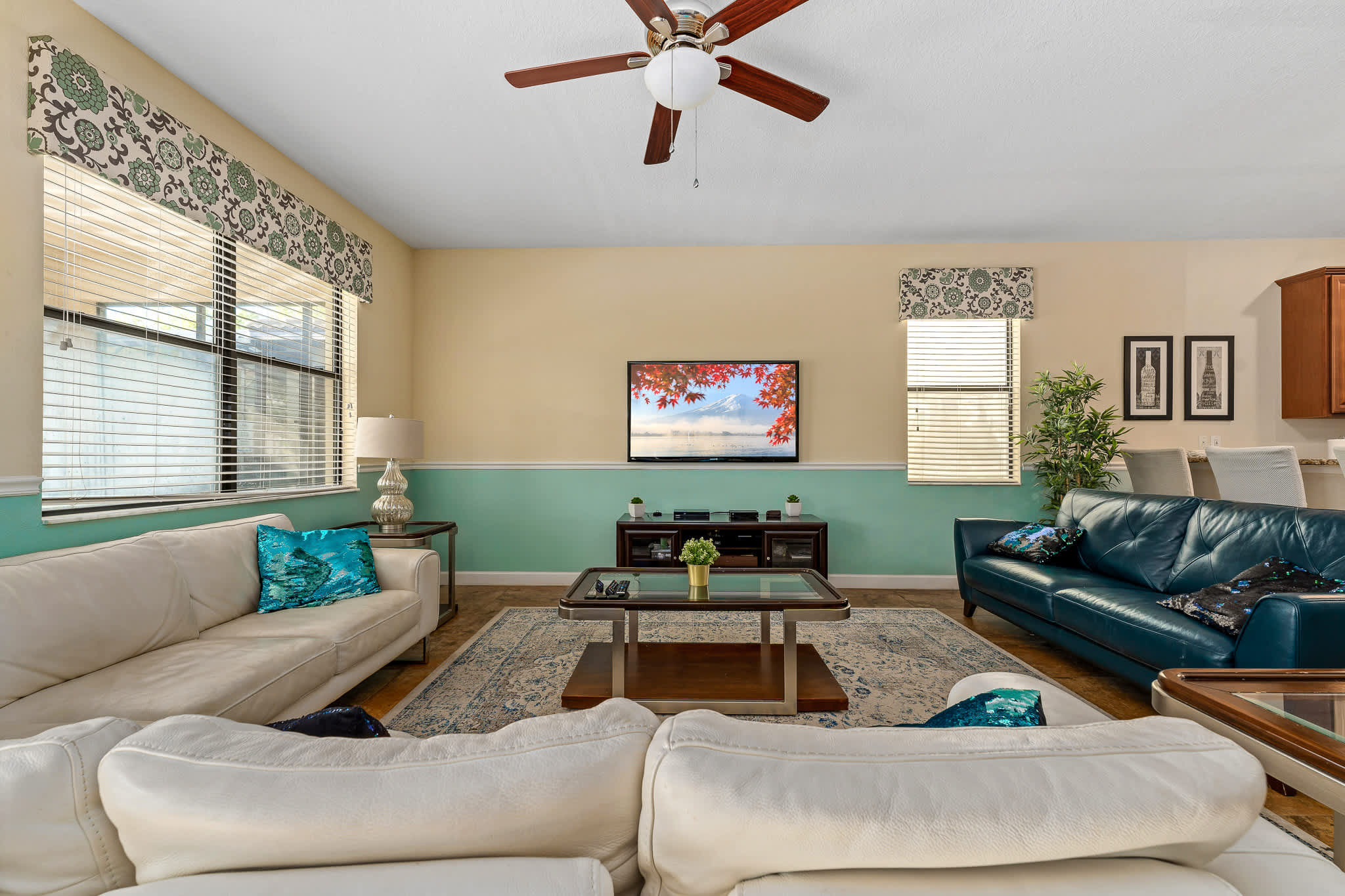 Bright living room with comfy seating and TV, ideal for relaxing after a day out.
