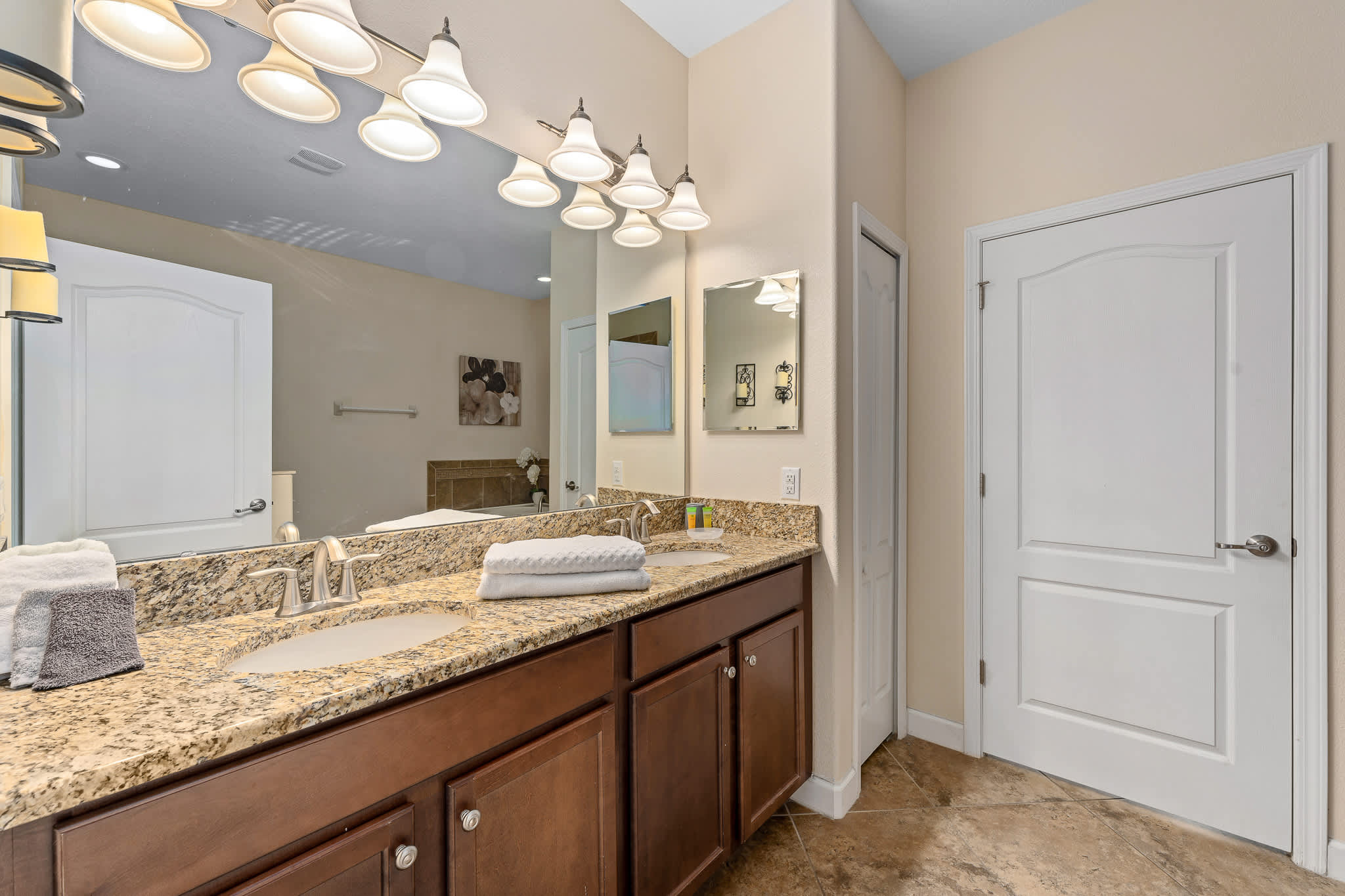 Bathroom vanity w/ sink and mirror, clean and spacious.