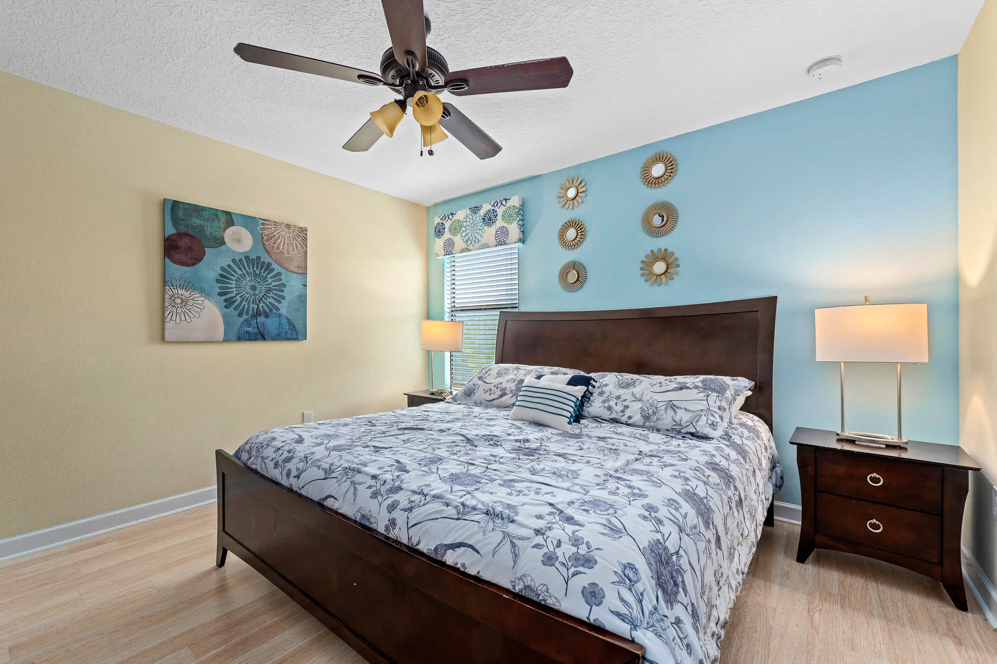 Bedroom w/ bed, ceiling fan, and soft tones for restful nights.