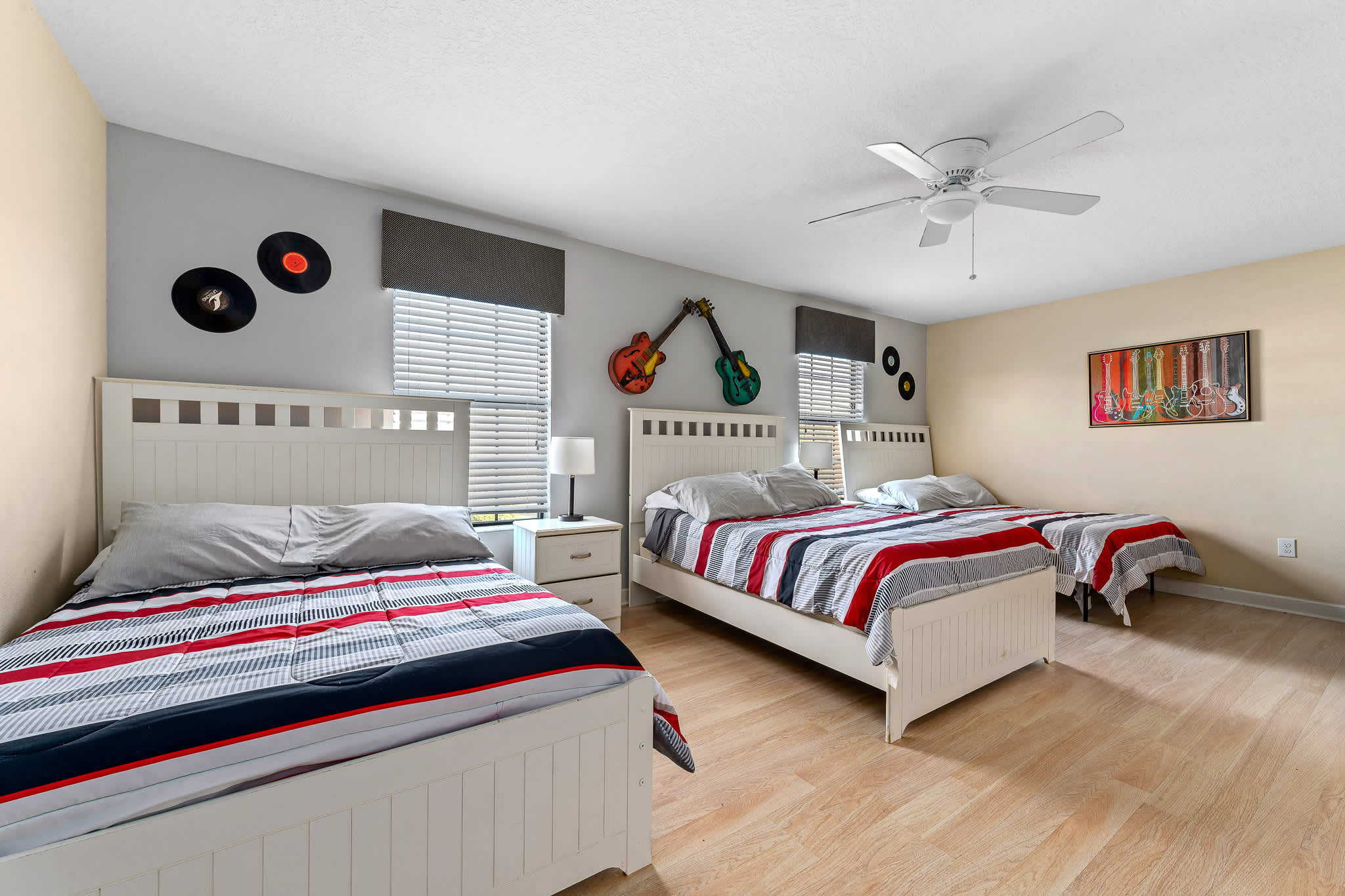 Colorful themed bedroom w/ bold decor and a bed full of character