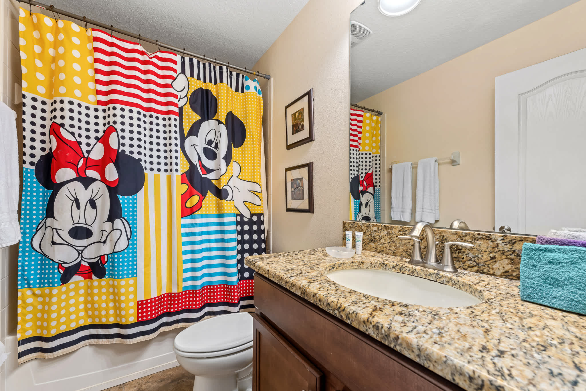 Bathroom vanity w/ sink and ample counter space.