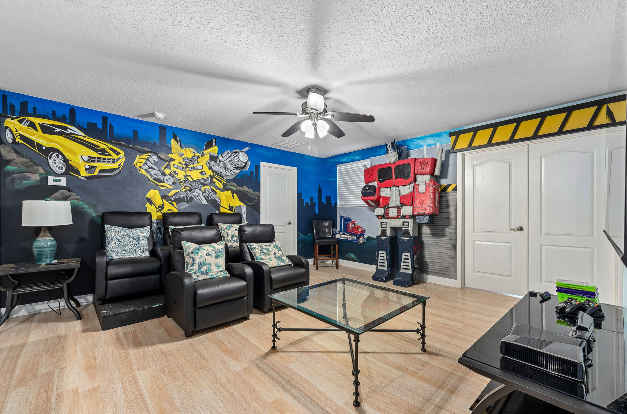 Game room w/ arcade games and seating, made for fun-filled hangouts.