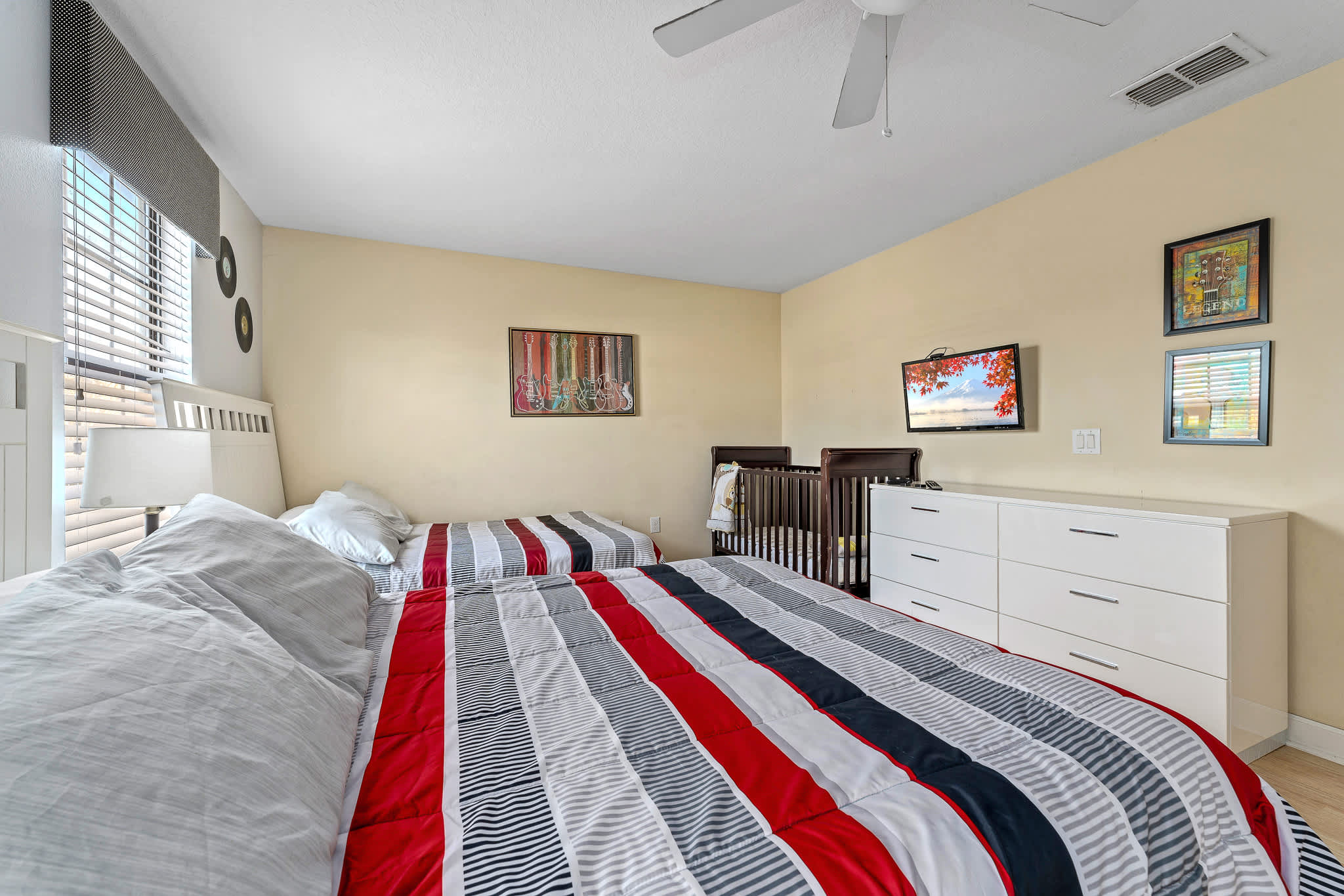 Spacious bedroom w/ bed and seating, ideal for unwinding comfortably.