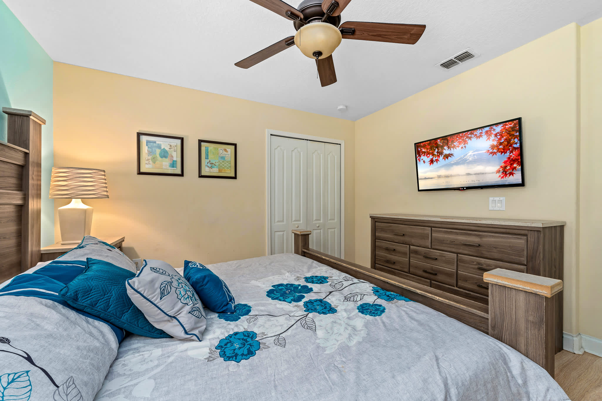 Bedroom w/ bed, ceiling fan, and dresser for added comfort.