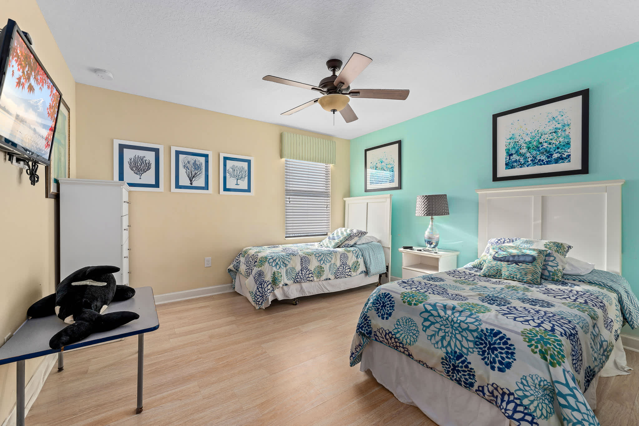 Bedroom w/ bed and wall art creating a relaxed vibe.