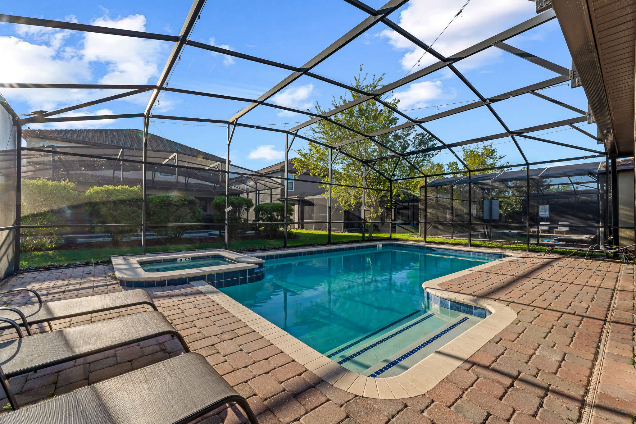 Screened-in pool & patio w/ seating, made for sunny days.