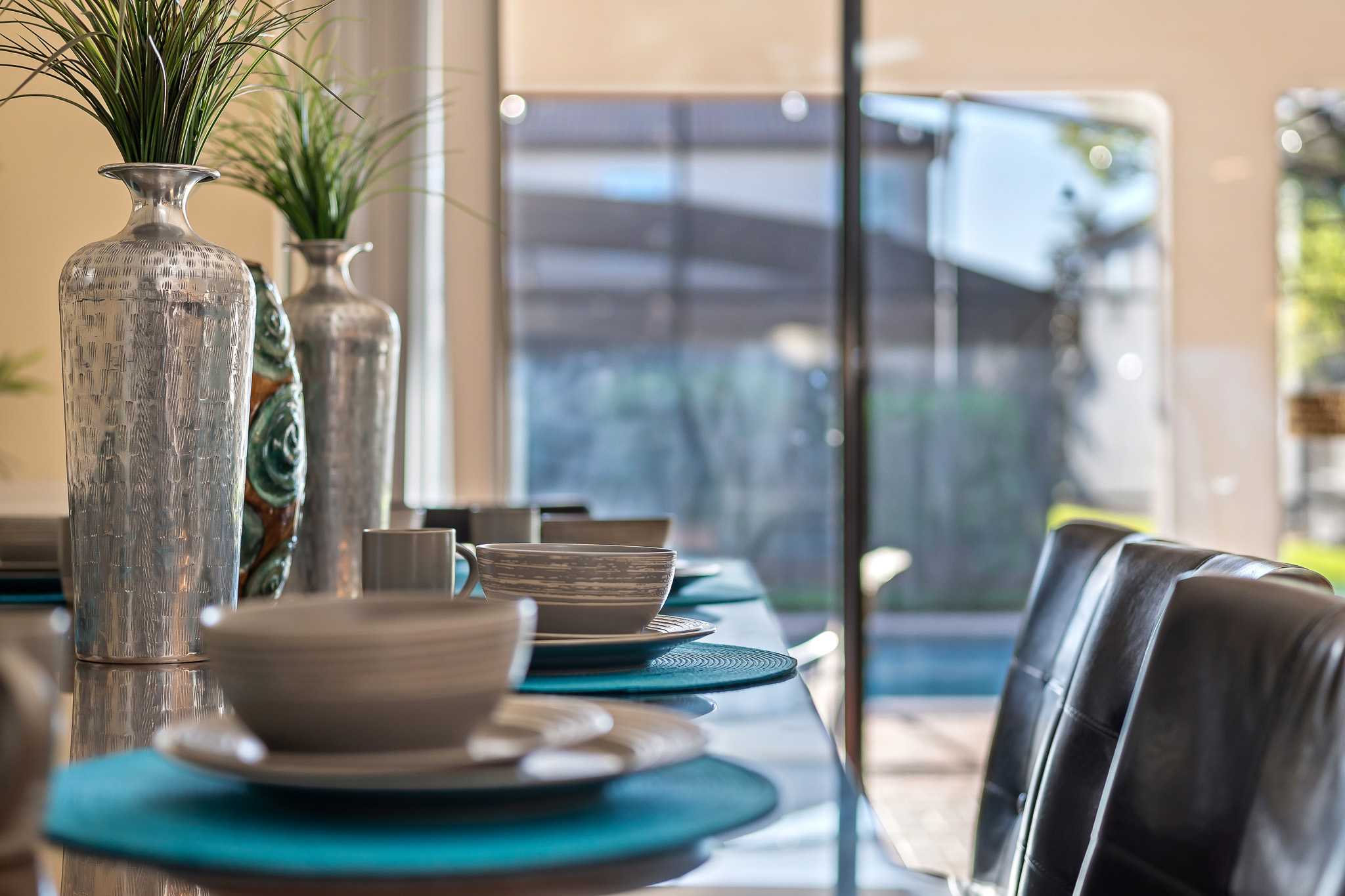 Dining table styled w/ tableware, ready for shared meals.