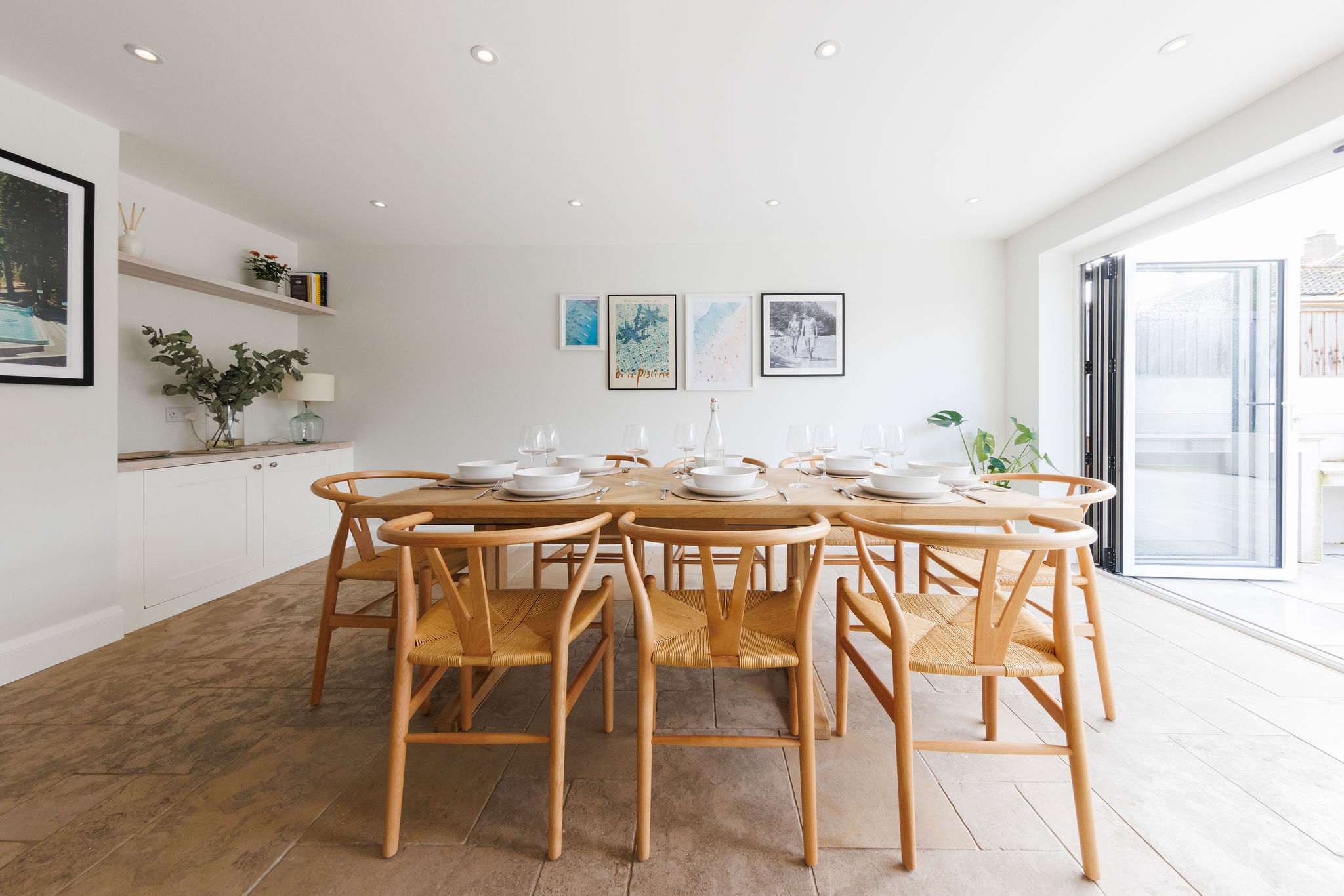 A modern dining table with wishbone chairs.