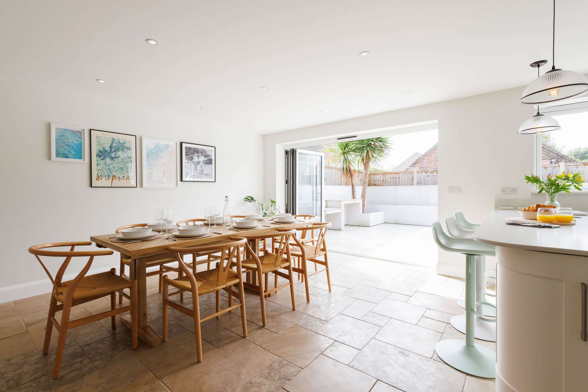 Open plan kitchen/dining area with bi-fold doors to the serene outdoor area.