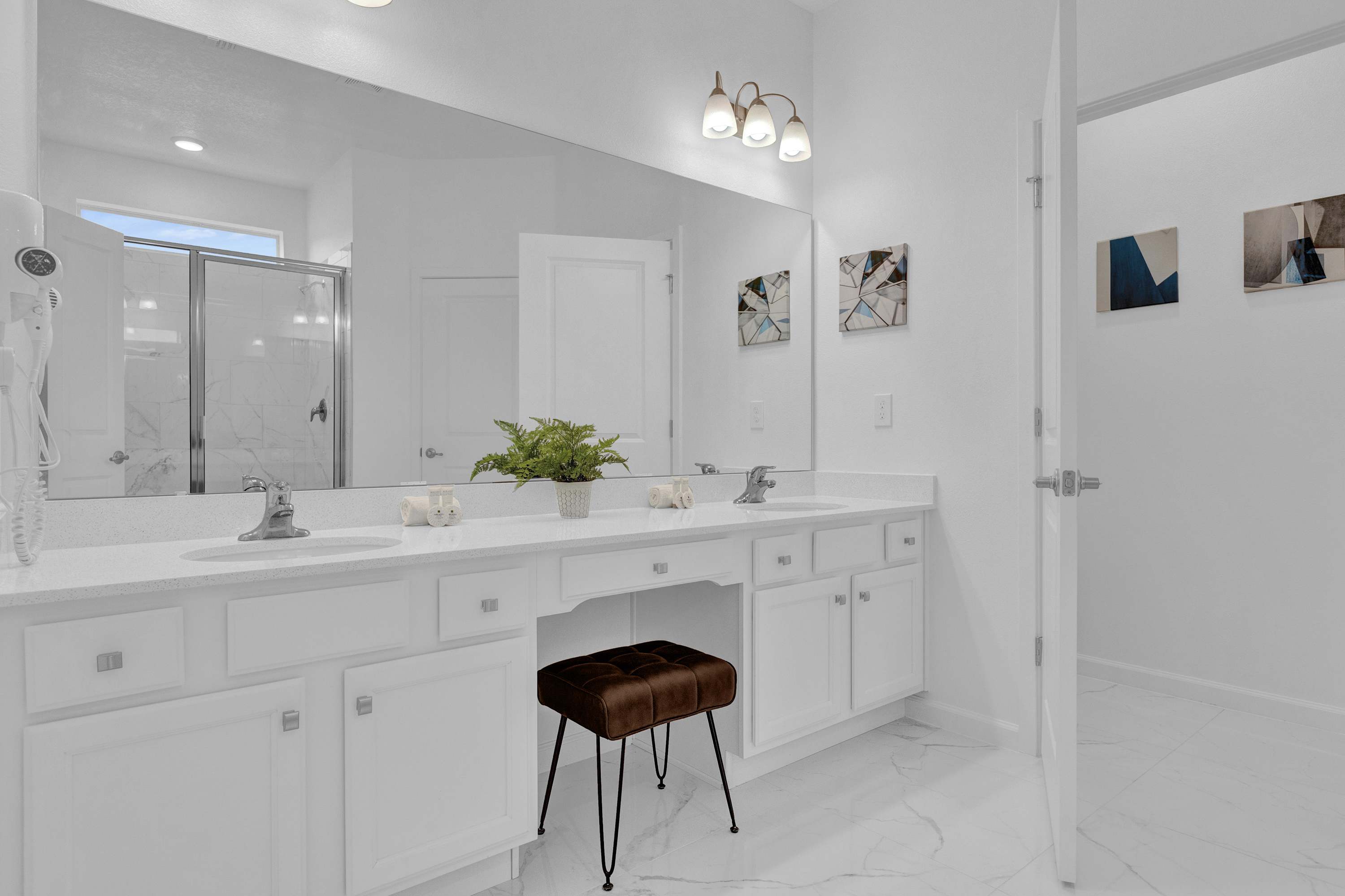 Spacious En-suite Bathroom with Dual Sinks and Standing Shower