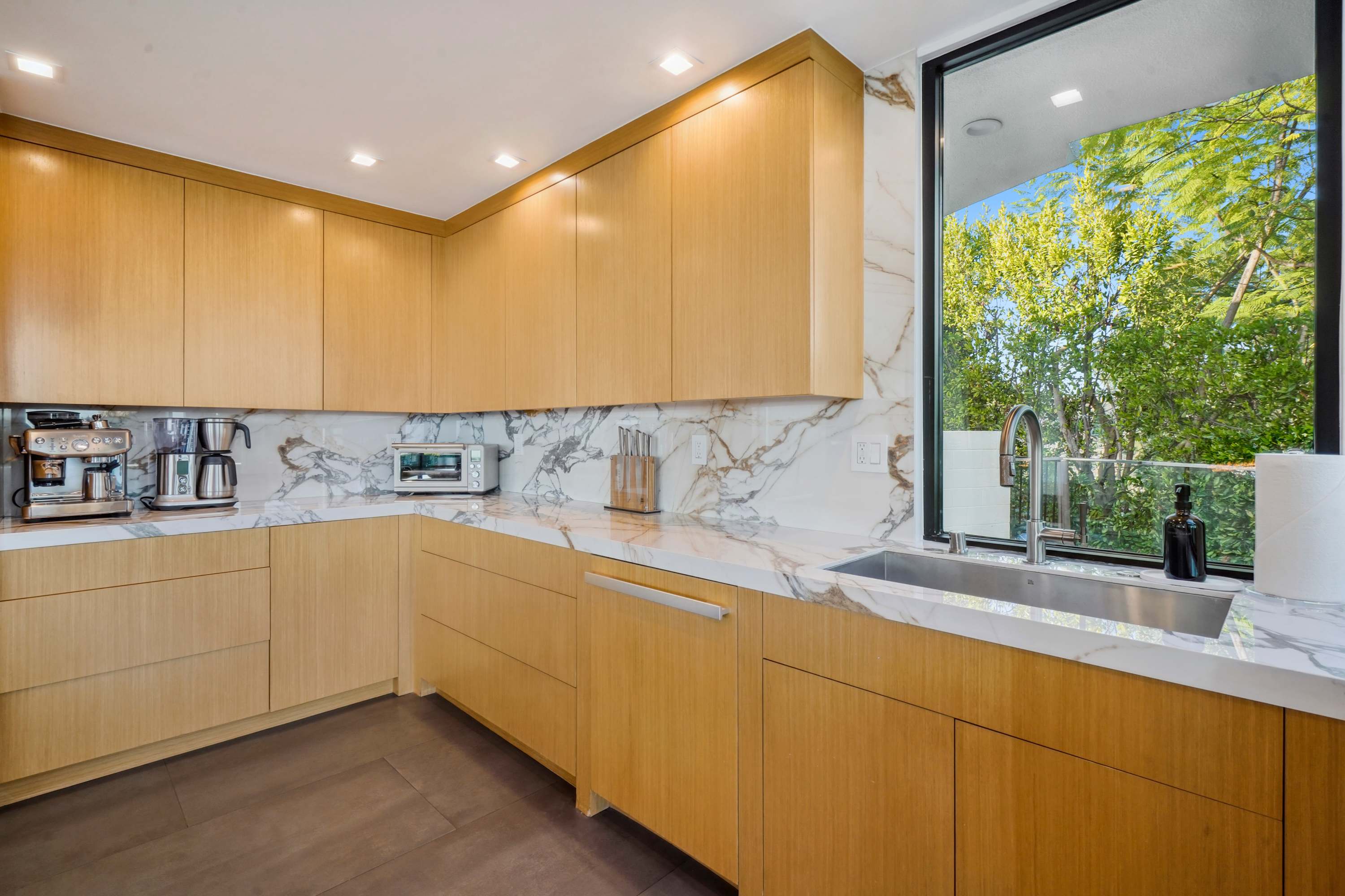 State-of-the-art kitchen with top-tier appliances, marble countertops, and custom cabinetry.