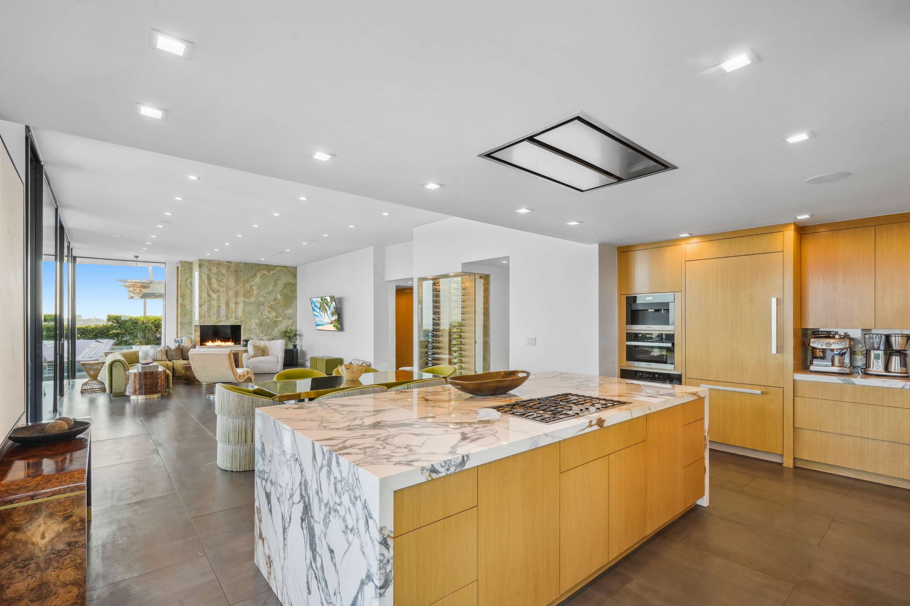 Marble island and custom cabinetry seamlessly blending into the sophisticated living area.