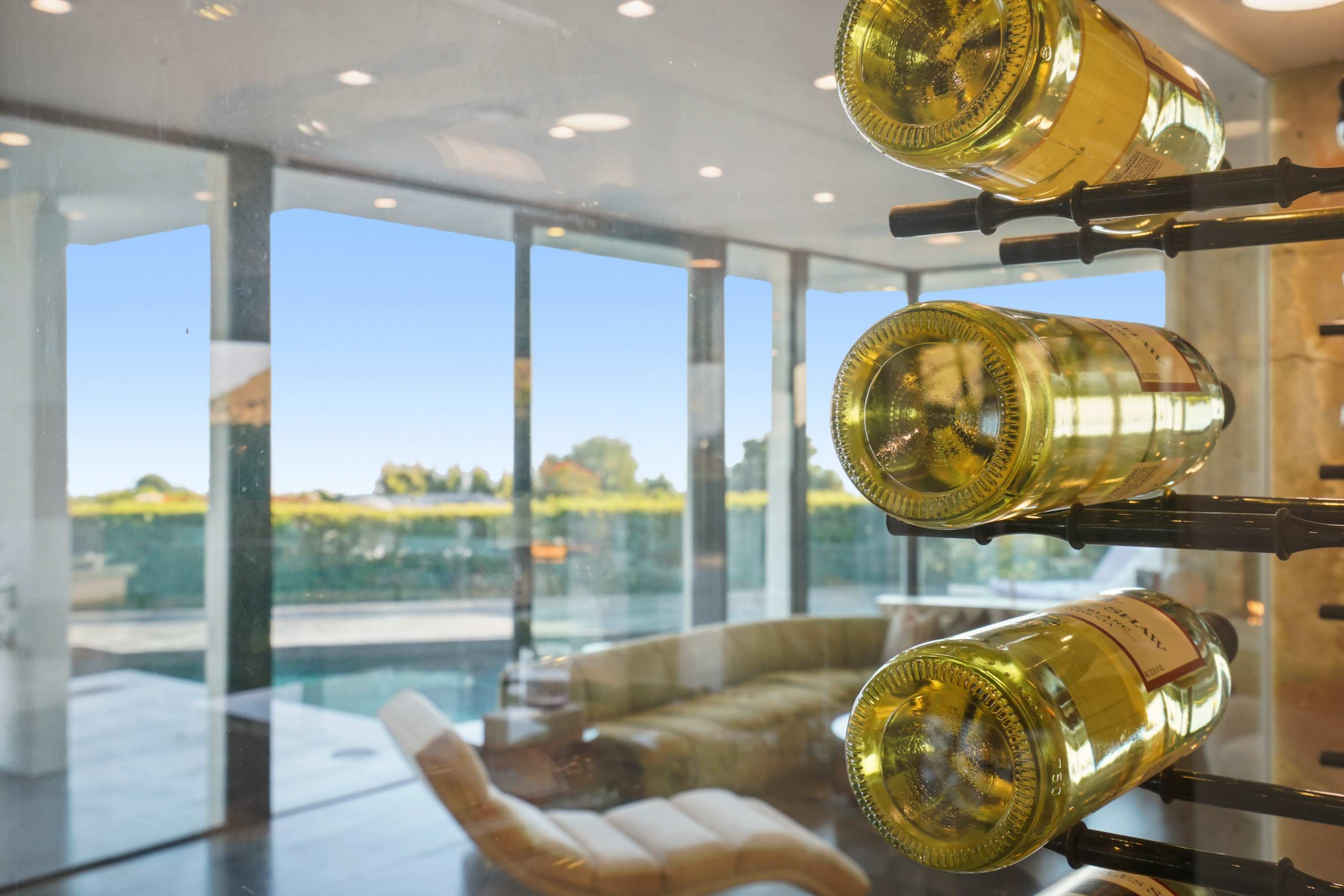 Sleek, modern wine rack framed by floor-to-ceiling glass, a perfect touch of sophistication.