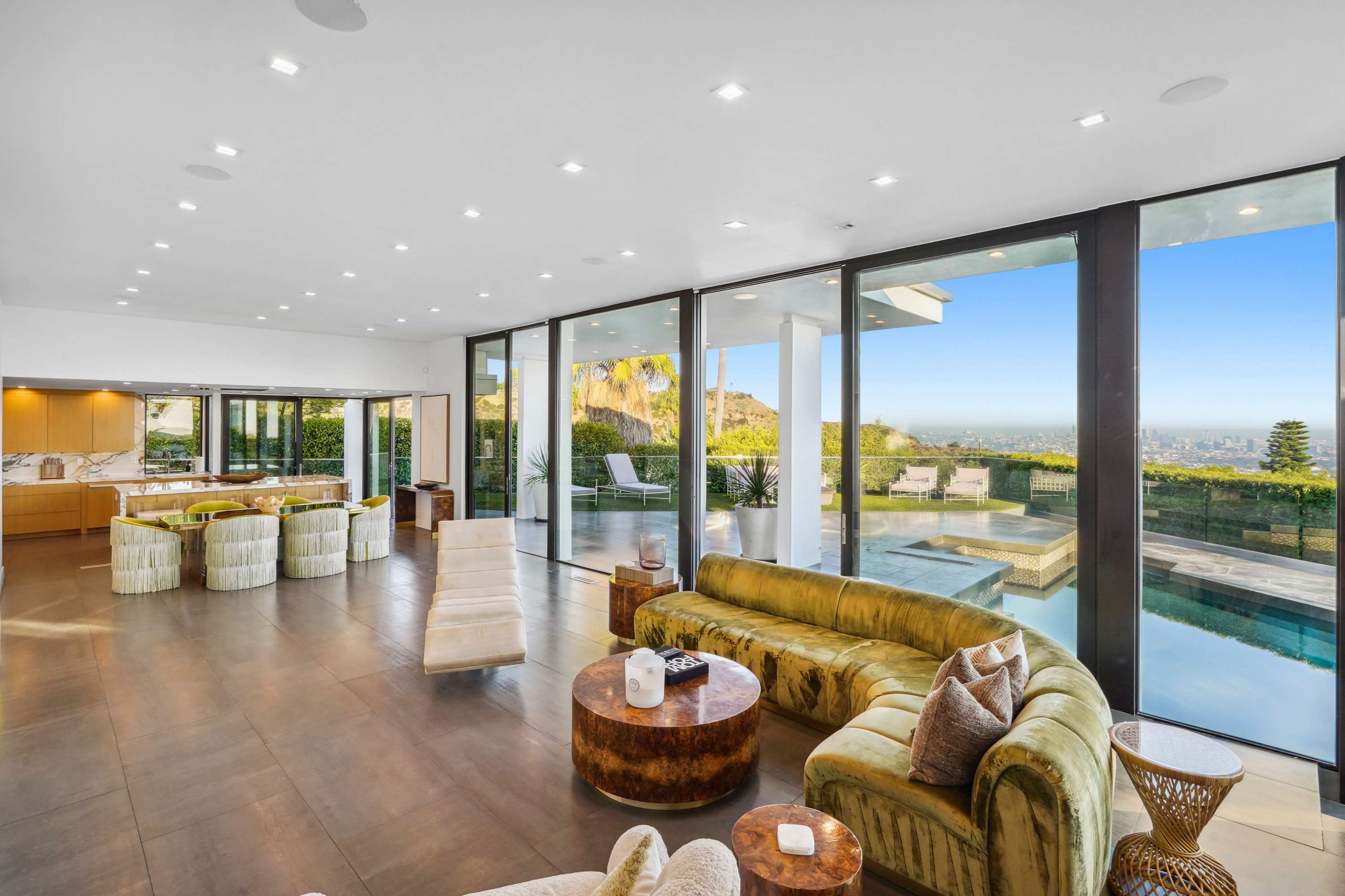 Open, sunlit living area with panoramic windows offering stunning outdoor views.