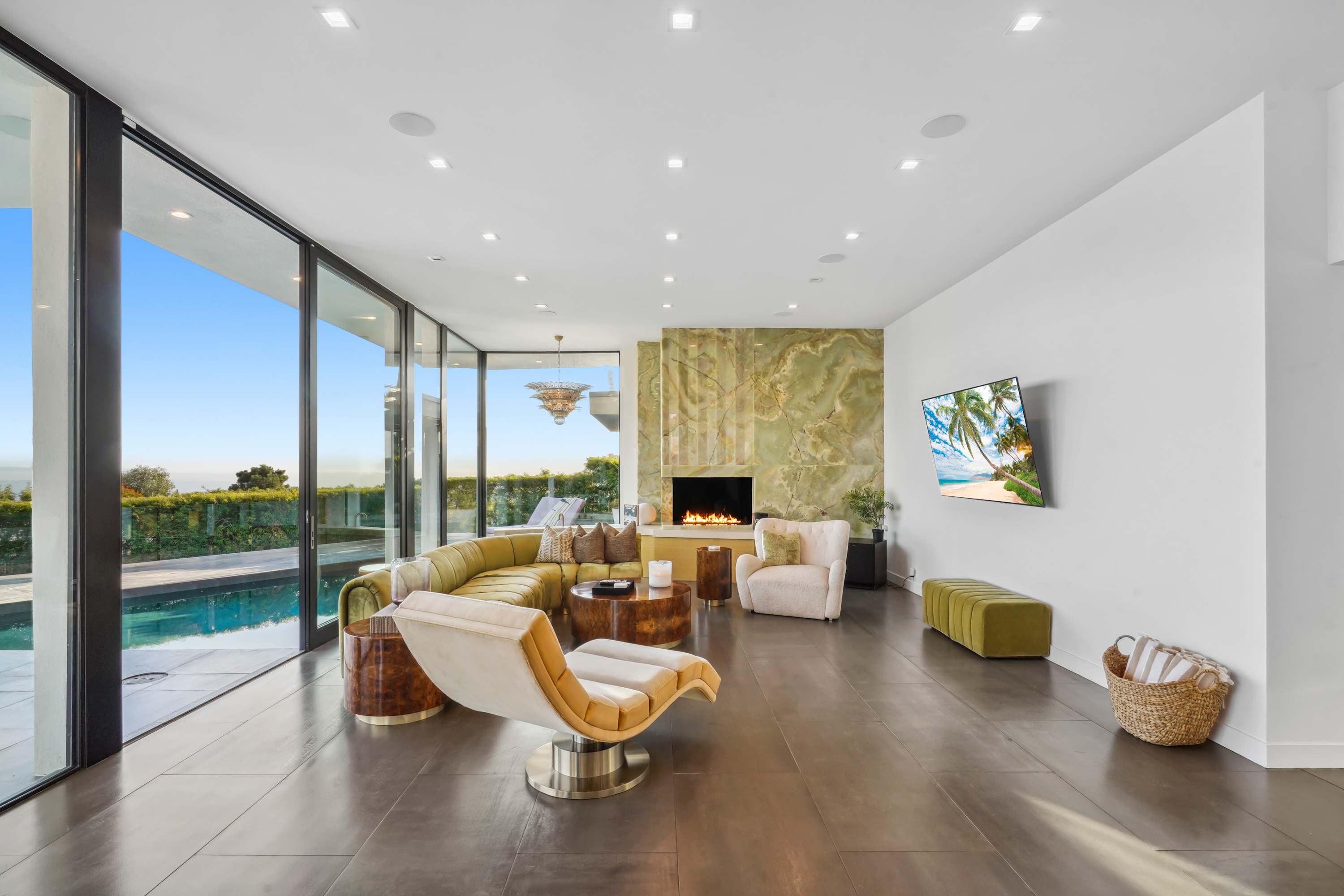 Connected seating and dining areas, wrapped in natural light from large glass windows.
