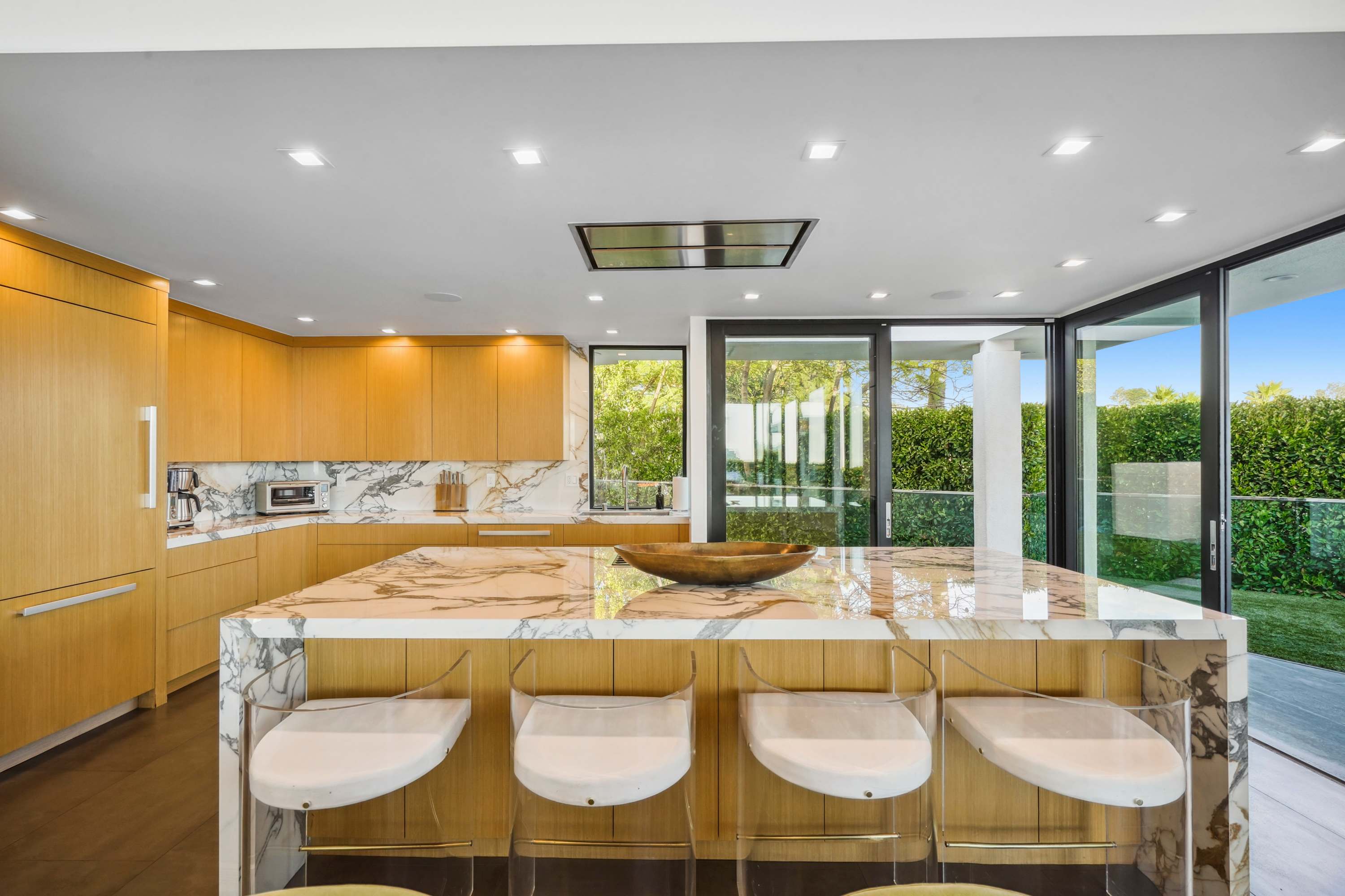 Gourmet kitchen with marble island, top-tier appliances, and modern finishes.