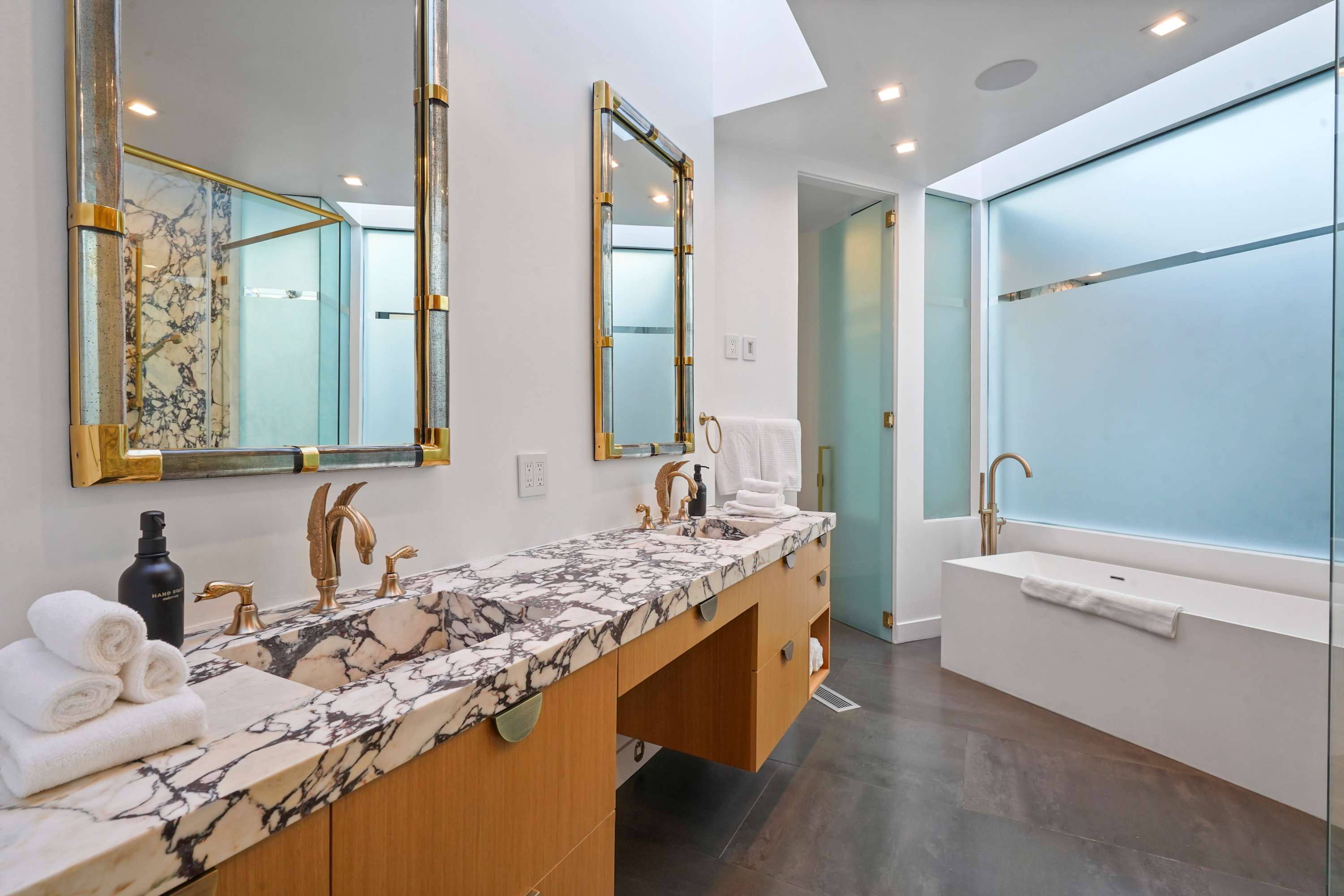 The deep soaking tub offers a serene escape, complemented by refined design elements throughout.