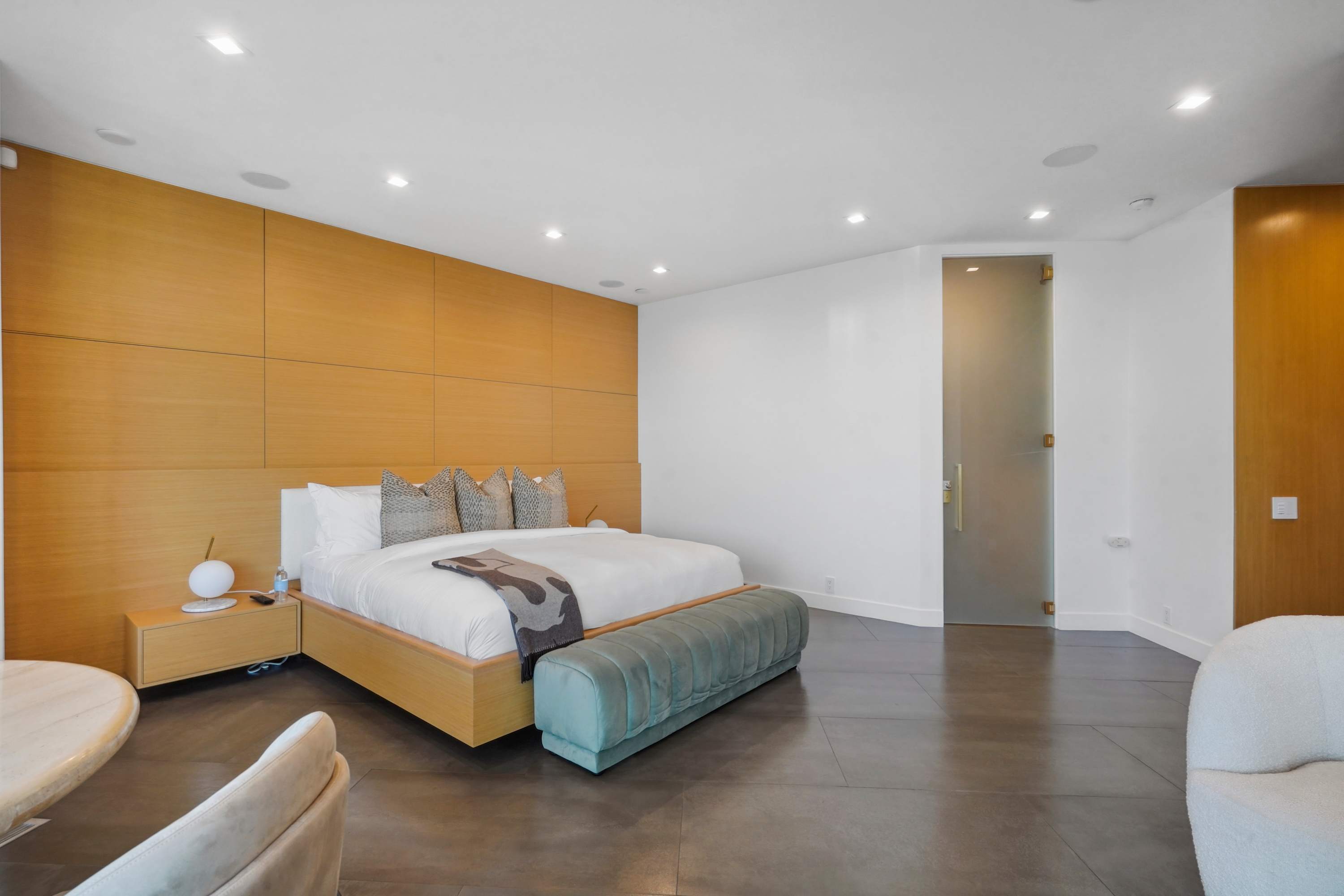 Minimalist design with plush bedding, soft lighting, and natural tones for ultimate comfort.