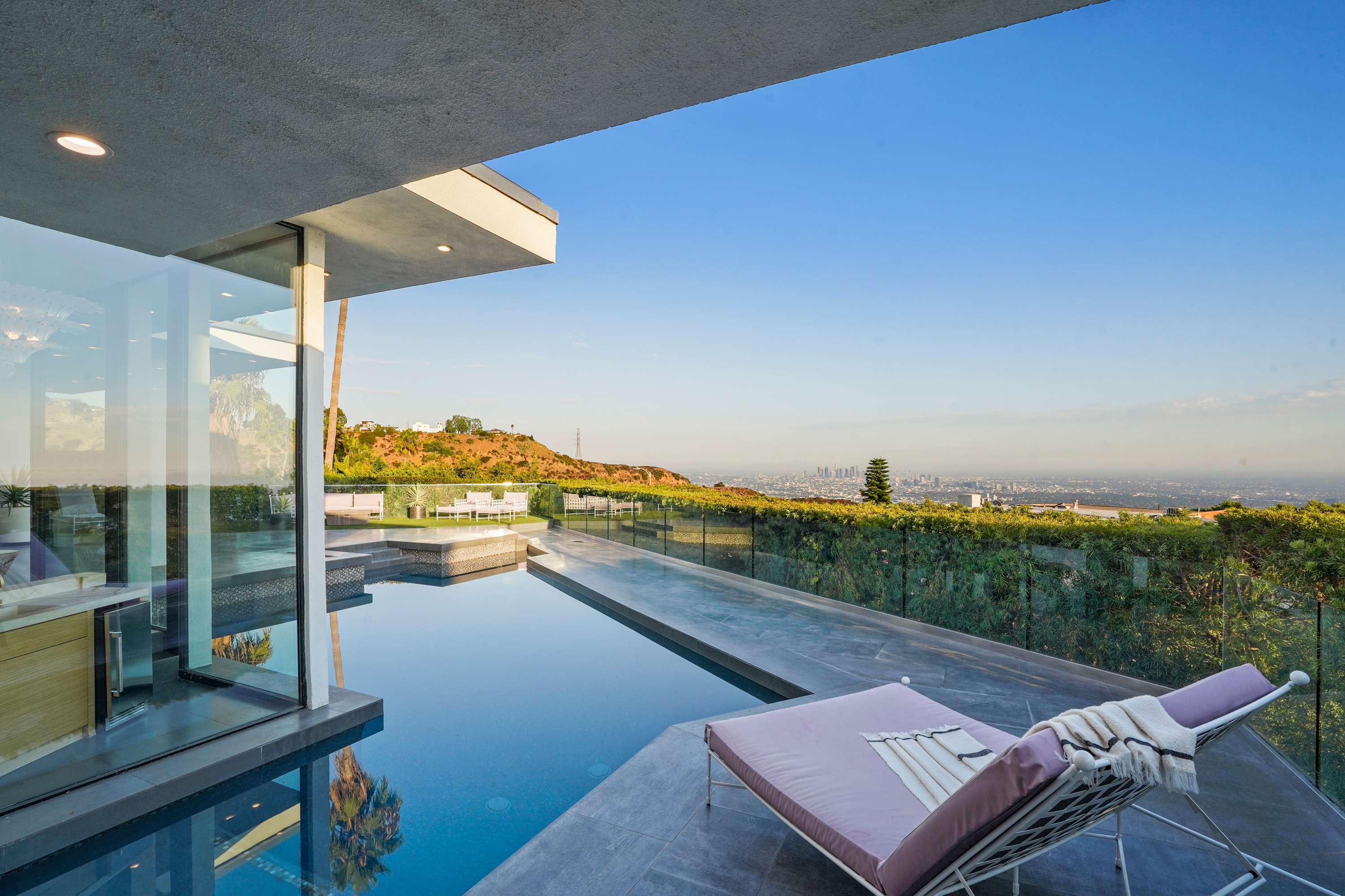 The poolside area includes shaded spots perfect for cooling off during sunny days.
