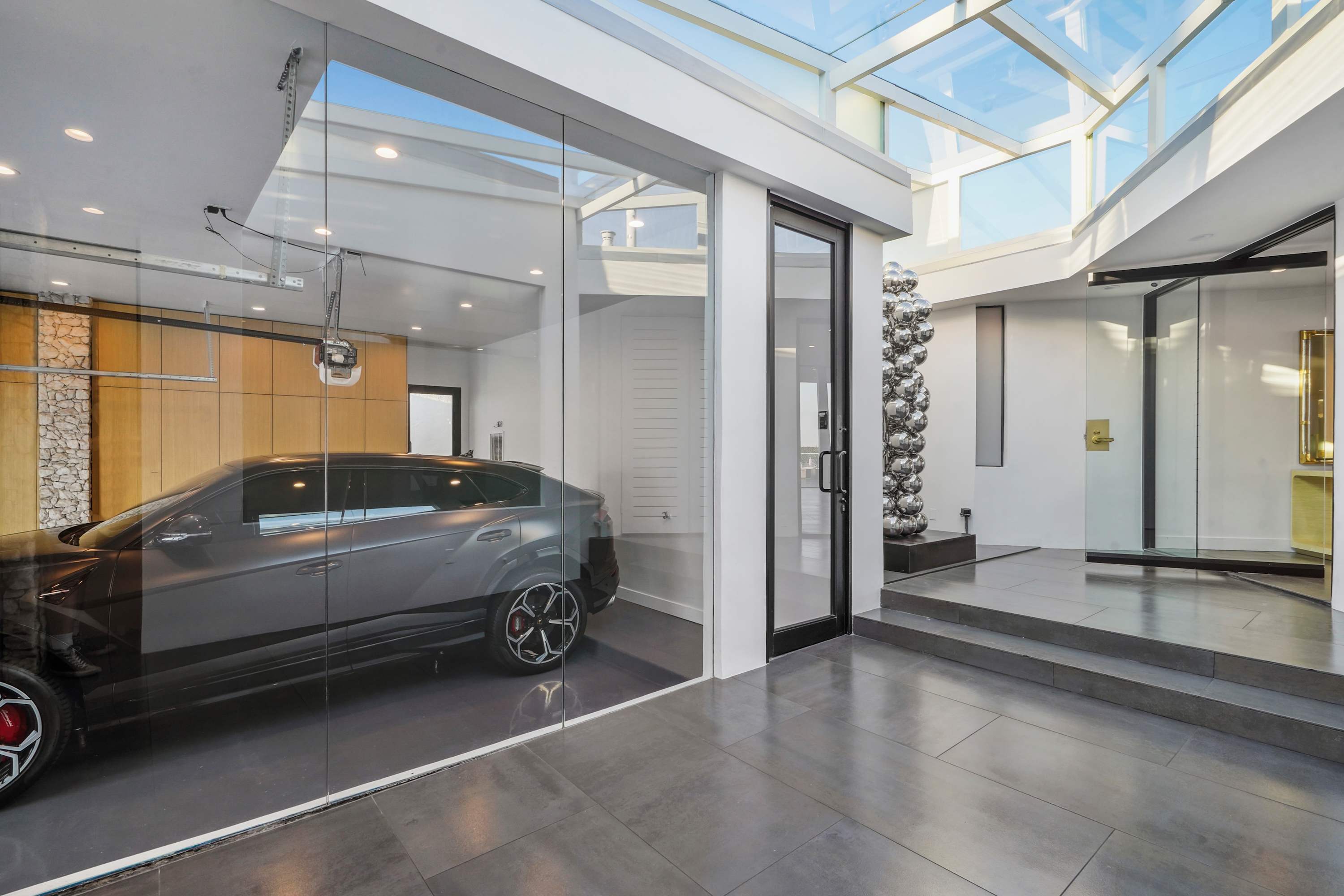 Modern garage with glass doors, ample space, and a bright, skylit design.