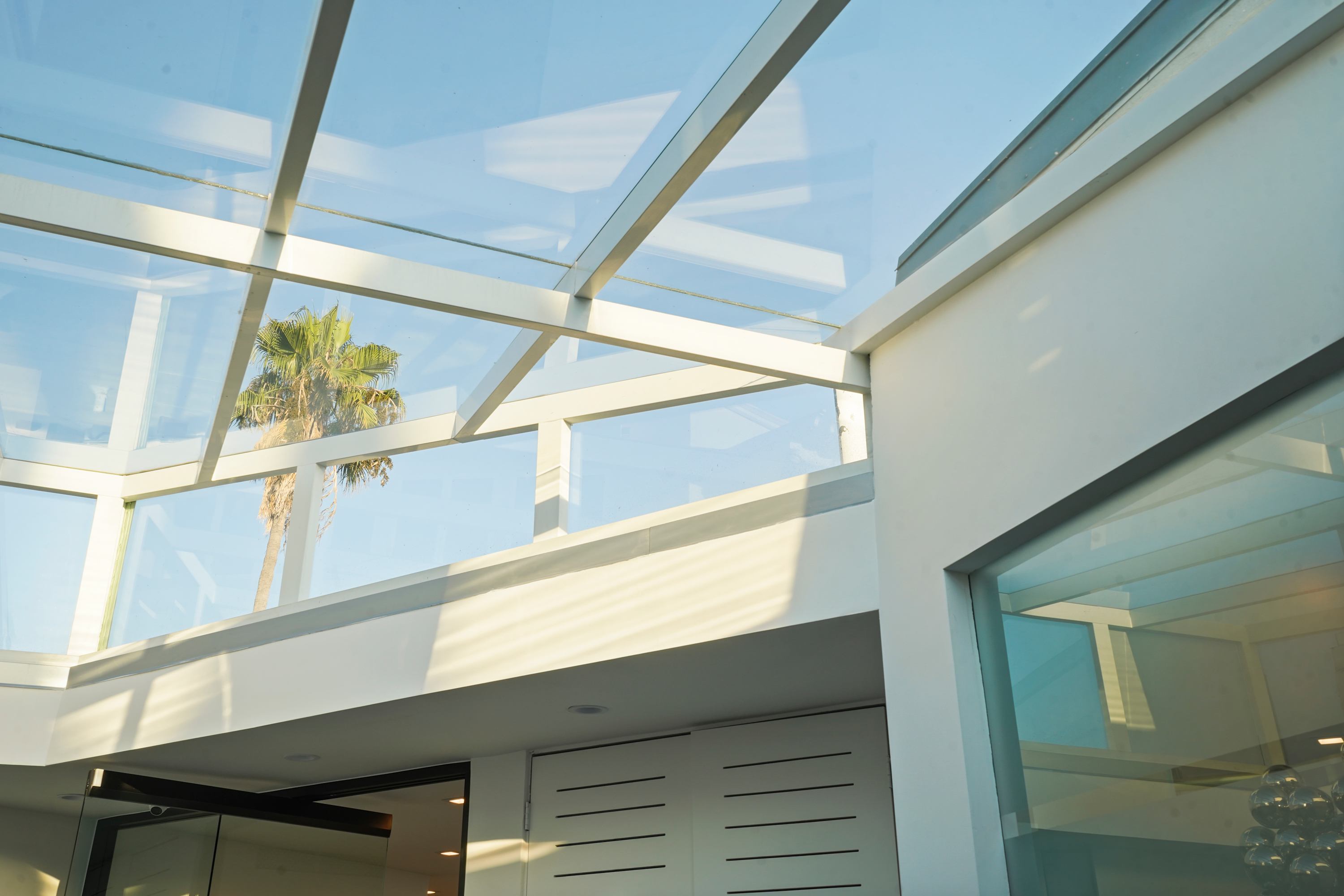 Bright entryway with glass ceilings and seamless modern design.