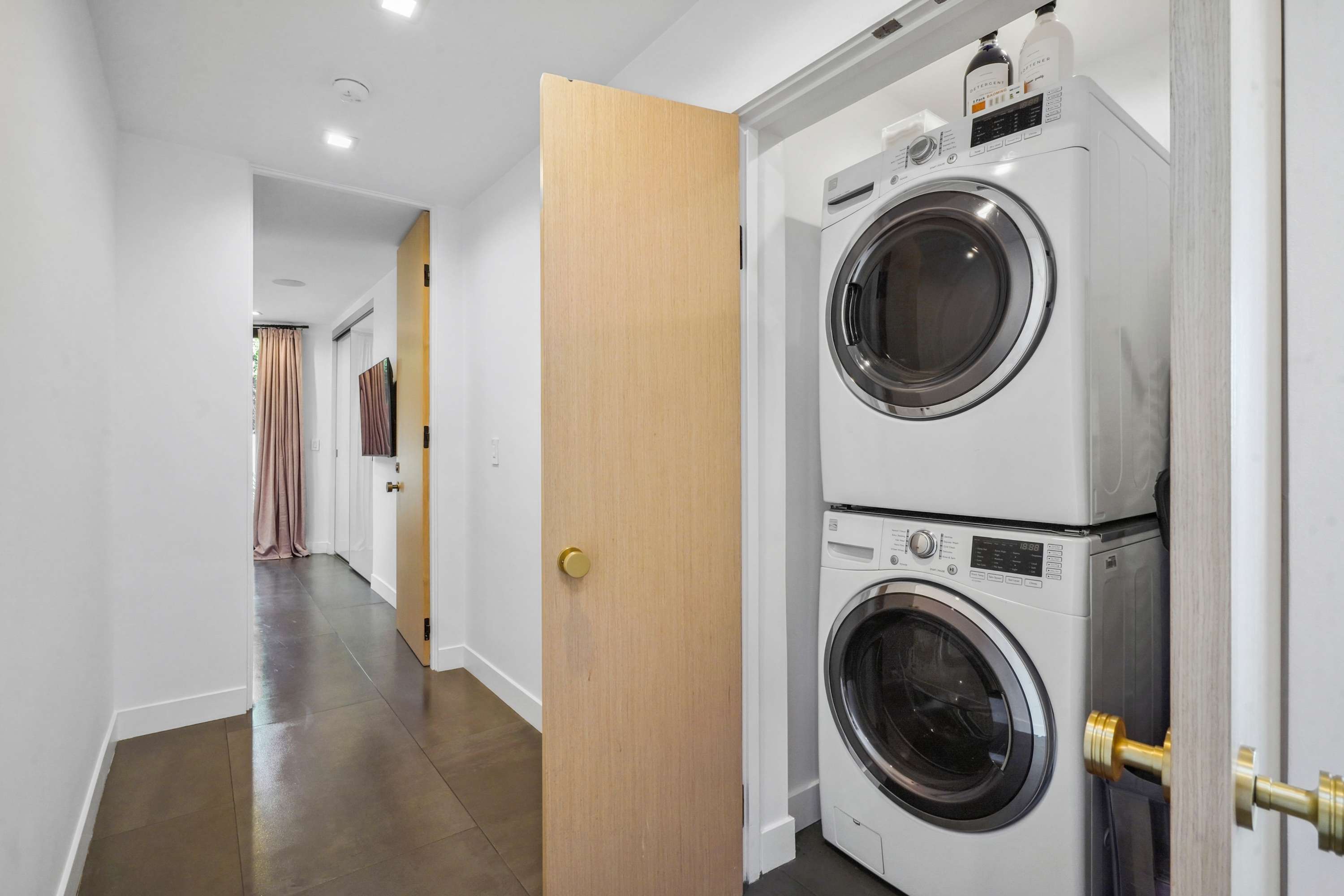 In-unit washer and dryer discreetly housed in a streamlined layout.