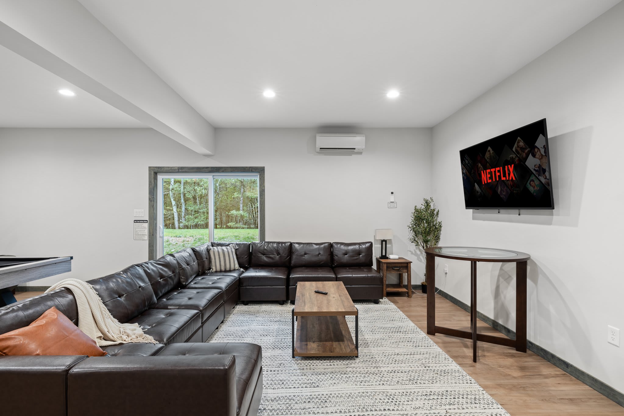 The perfect setup for binge-watching or game day, with a large sectional and wall-mounted TV ready to go.