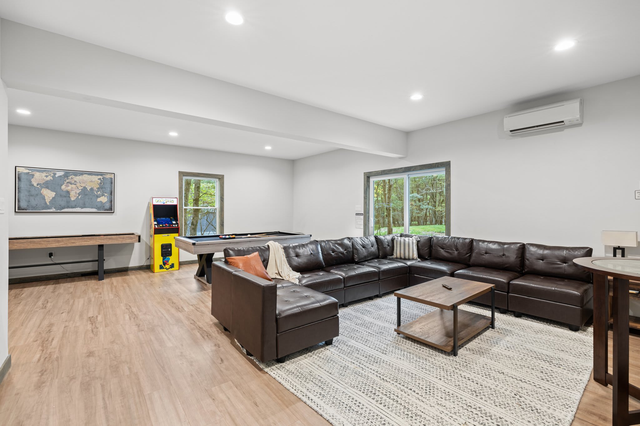 Game Lounge with Seating
A spacious downstairs living area with plenty of seating, games, and open space for the whole group to enjoy.