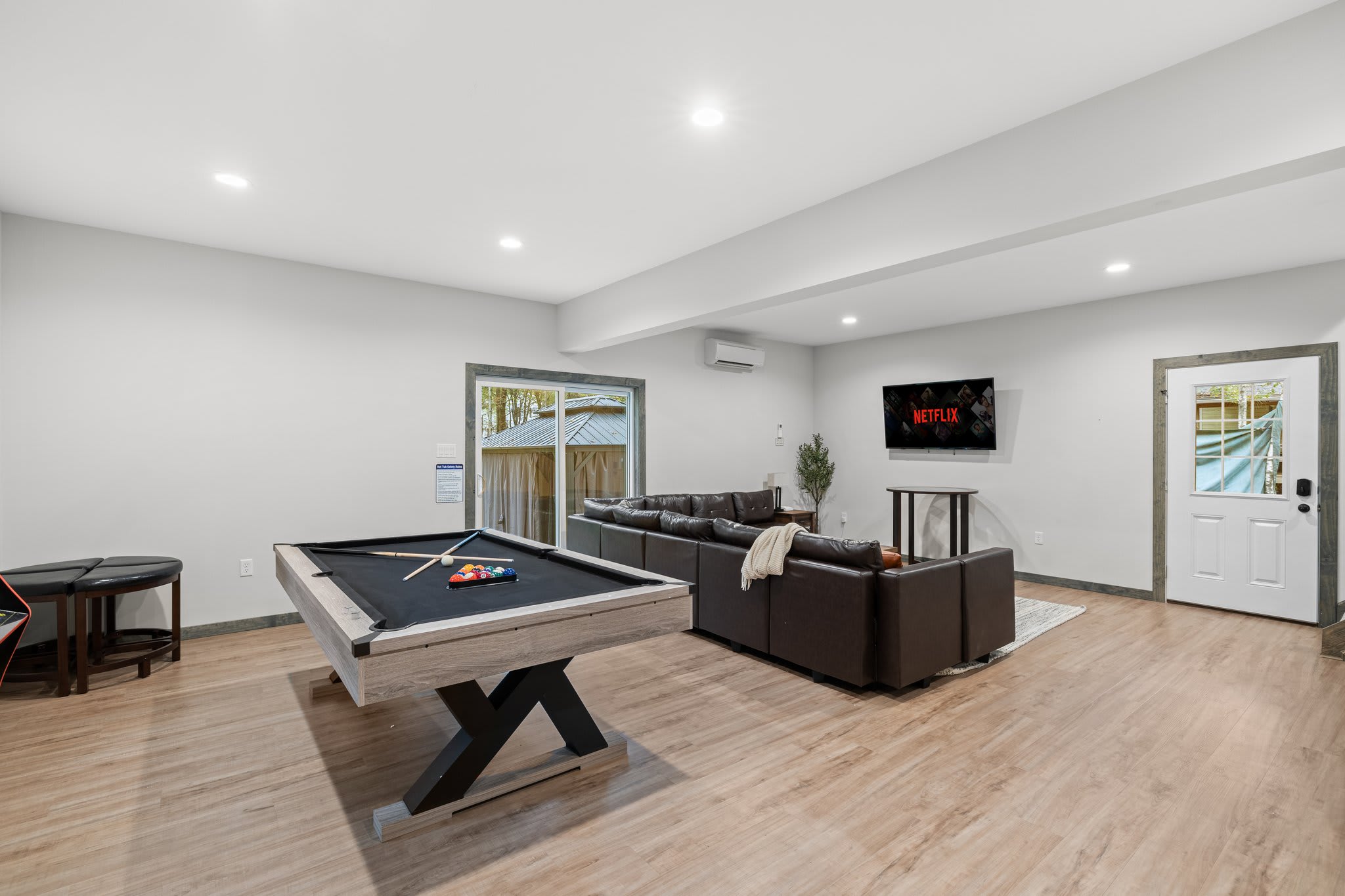 Spacious, open, and easy to enjoy. From pool games to TV time, everything flows naturally in this lower-level hangout.