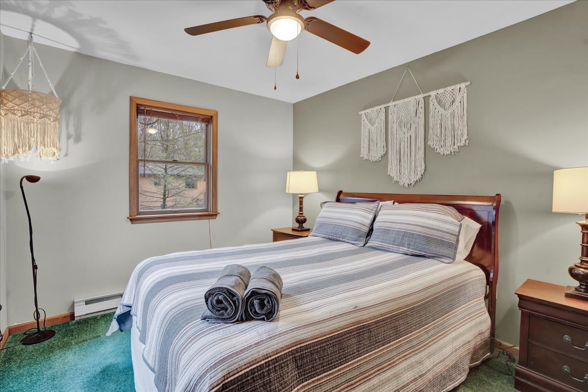 Cozy & Chic Guest Bedroom – A bright and welcoming bedroom with soft linens, warm lighting, and a touch of boho charm for a relaxing atmosphere.