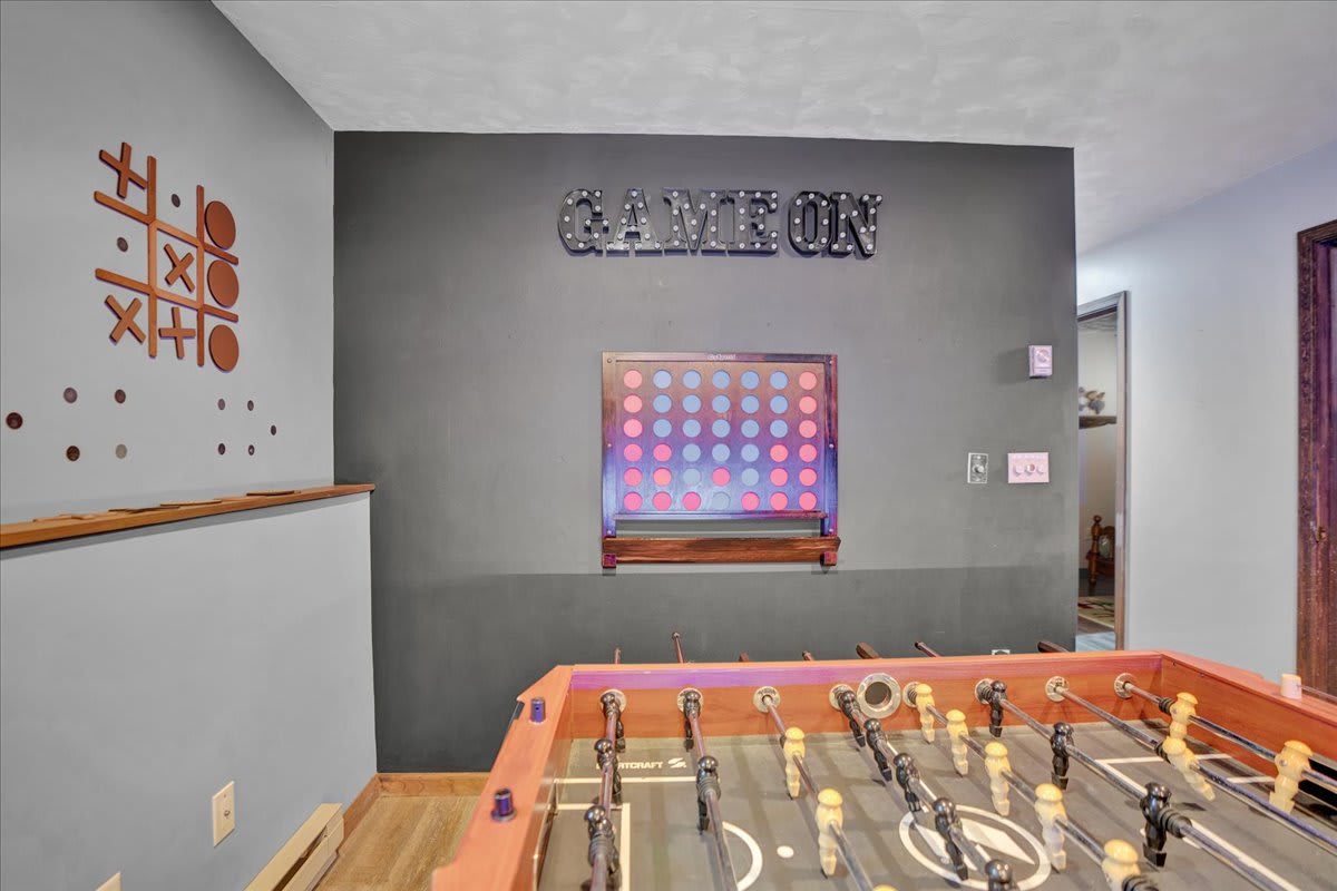 Game Room Fun – A playful and inviting game area with a foosball table and wall decor that sets the tone for friendly competition.