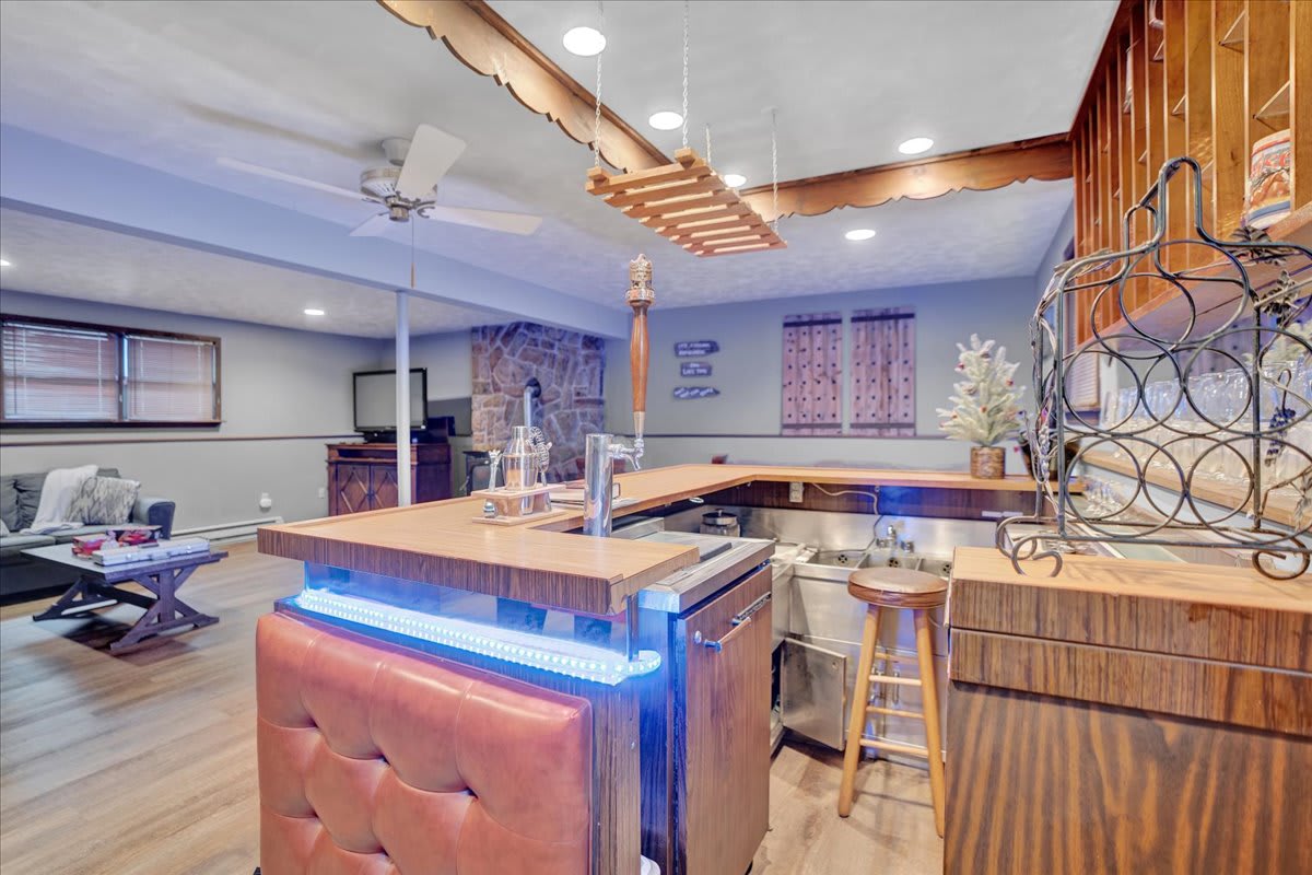 Vibrant Bar & Entertainment Hub – A stylish bar area with glowing LED lights, high-top seating, and an inviting atmosphere for entertaining.