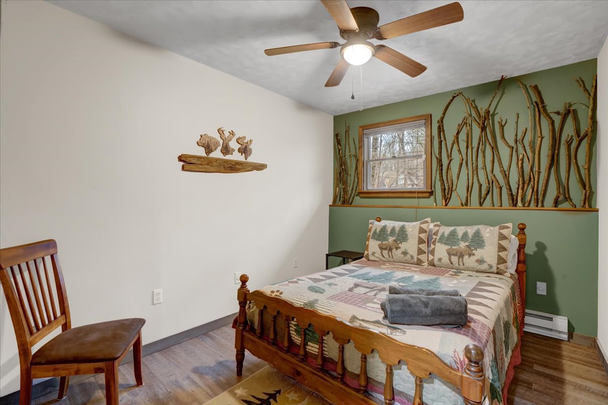 Charming Nature-Inspired Bedroom – A cozy retreat with wooden details, nature-themed decor, and a warm color palette for a relaxing stay.