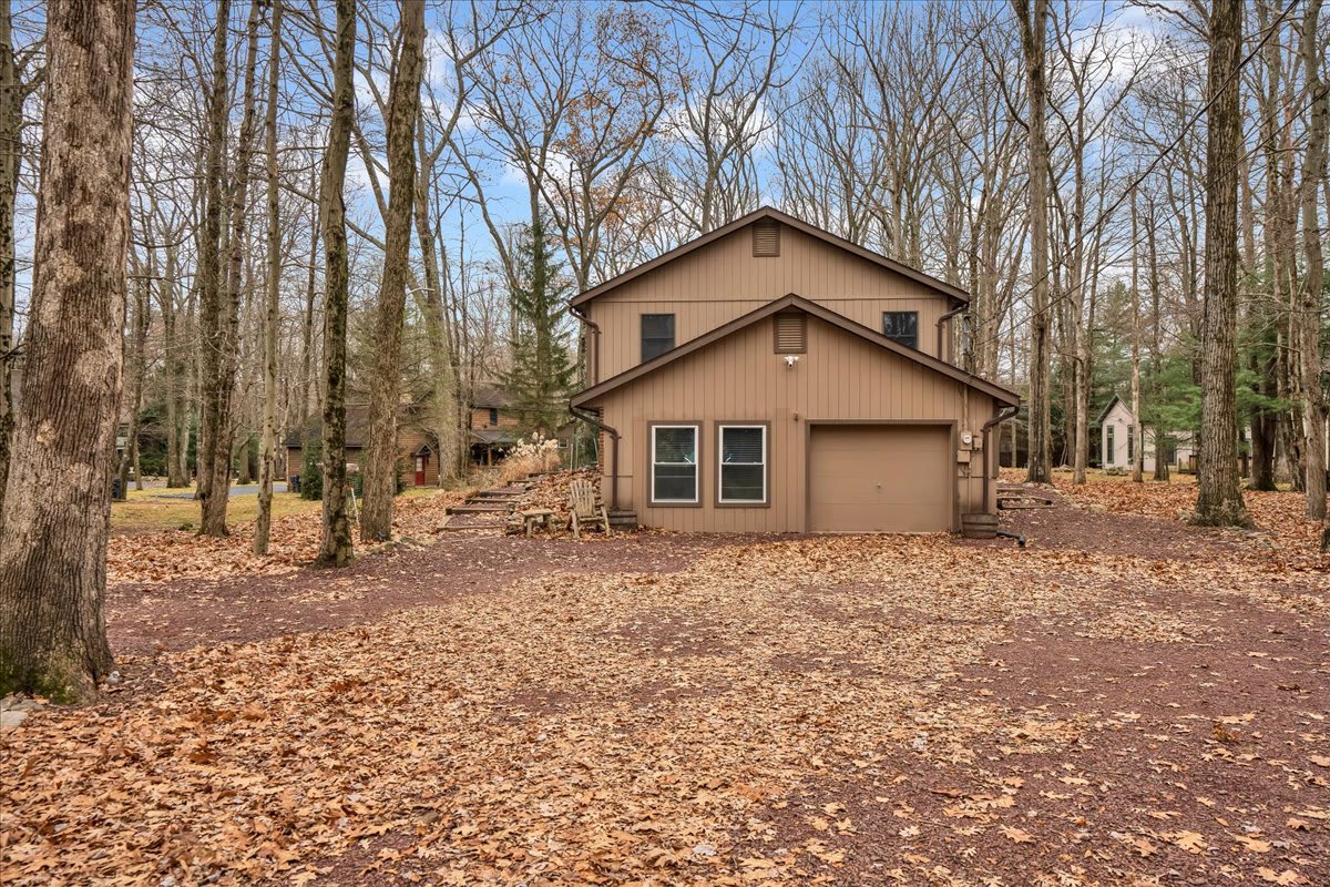 Cozy Woodland Escape – This inviting home blends seamlessly with its wooded surroundings, providing a serene and private retreat.