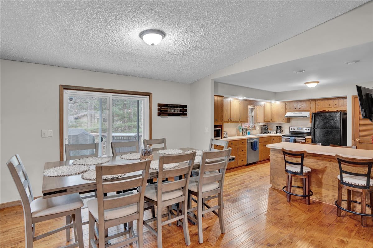 Bright & Inviting Dining Area – A spacious dining setup with a wooden table and natural light pouring in, creating a cozy mealtime setting.
