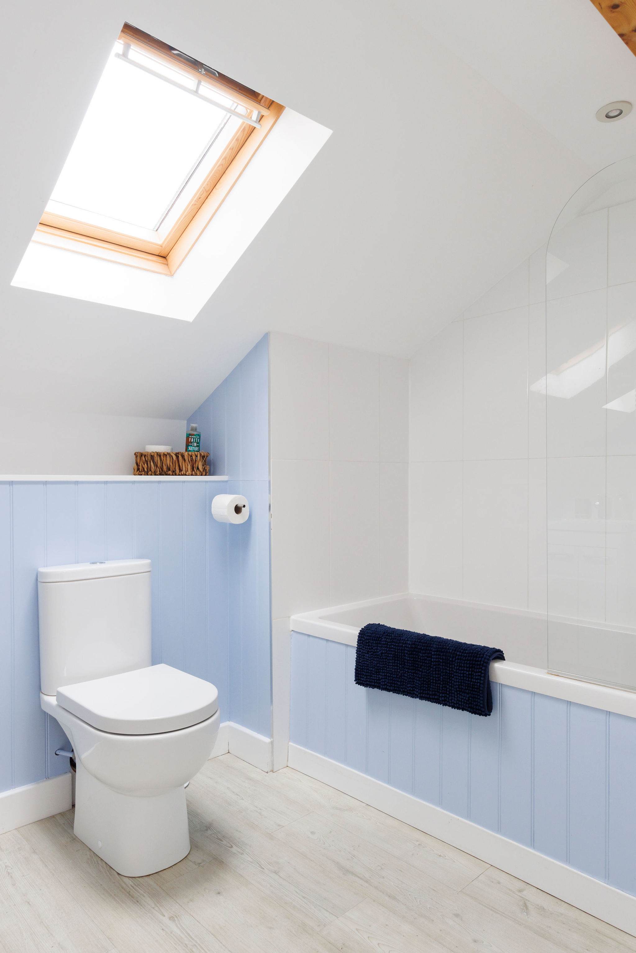 The upstairs bathroom is decorated in a soft blue.