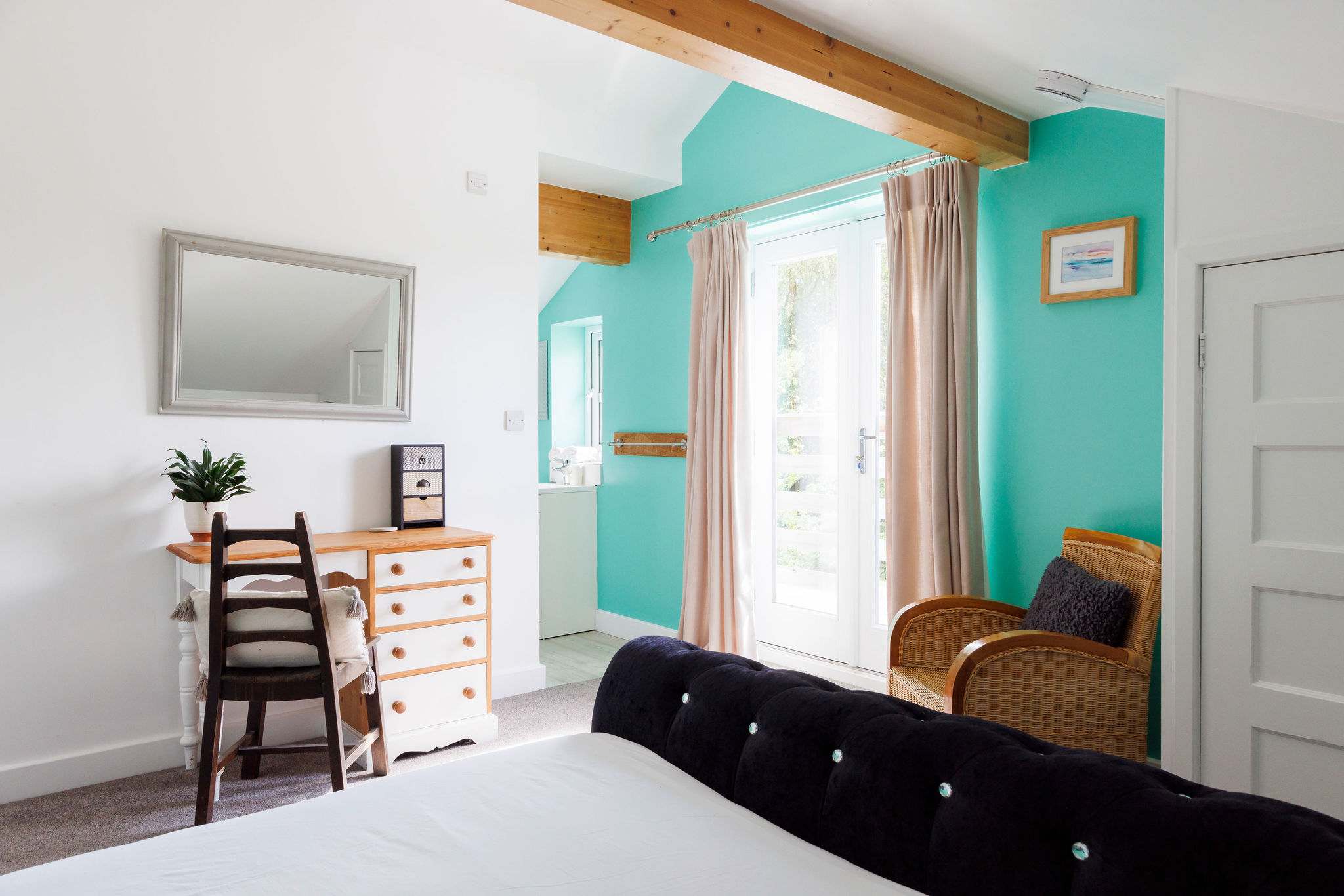 The master bedroom features a plush king bed, bright colours and elegant touches.