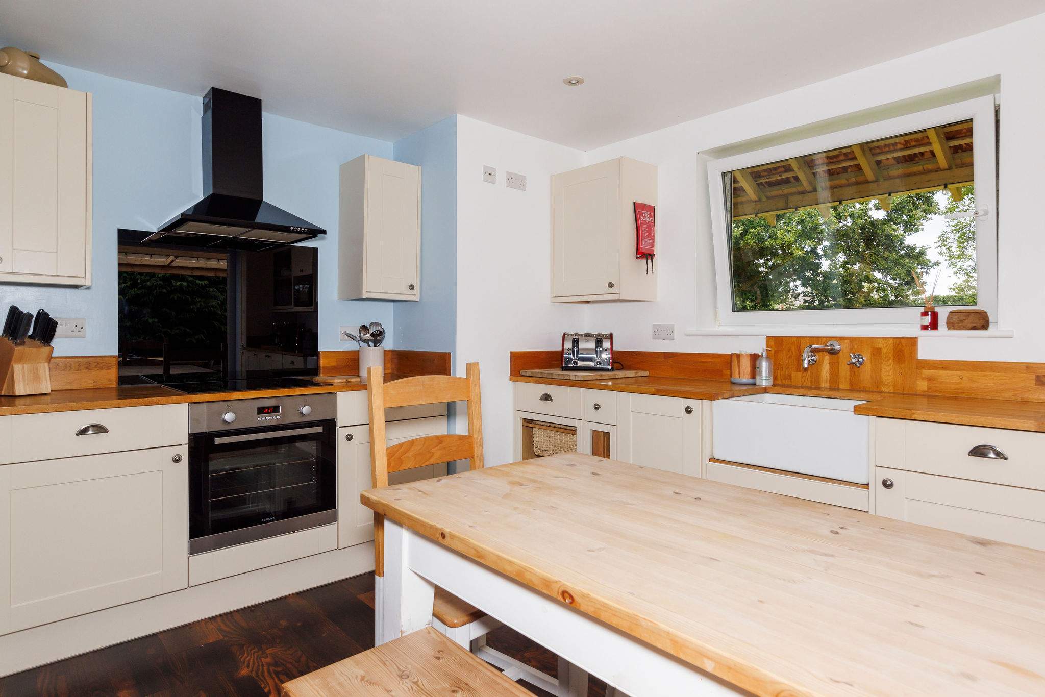 Cook up a feast in the charming, country-style kitchen, complete with modern appliances, wooden countertops, and a large dining area for family meals.