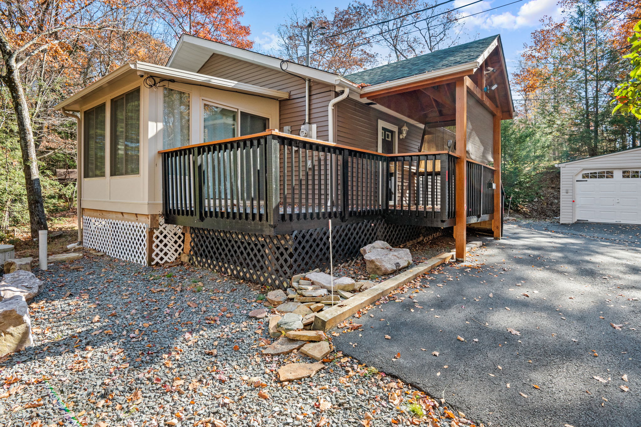 Large windows and an inviting deck showcase the natural surroundings, perfect for quiet mornings or sunset views.